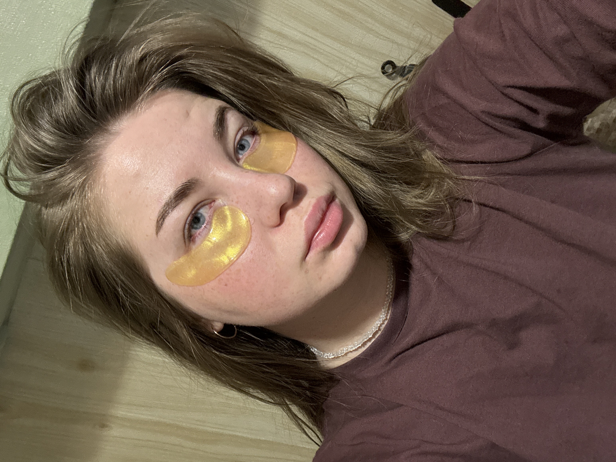 Woman documents skincare routine with golden eye patches in Russia