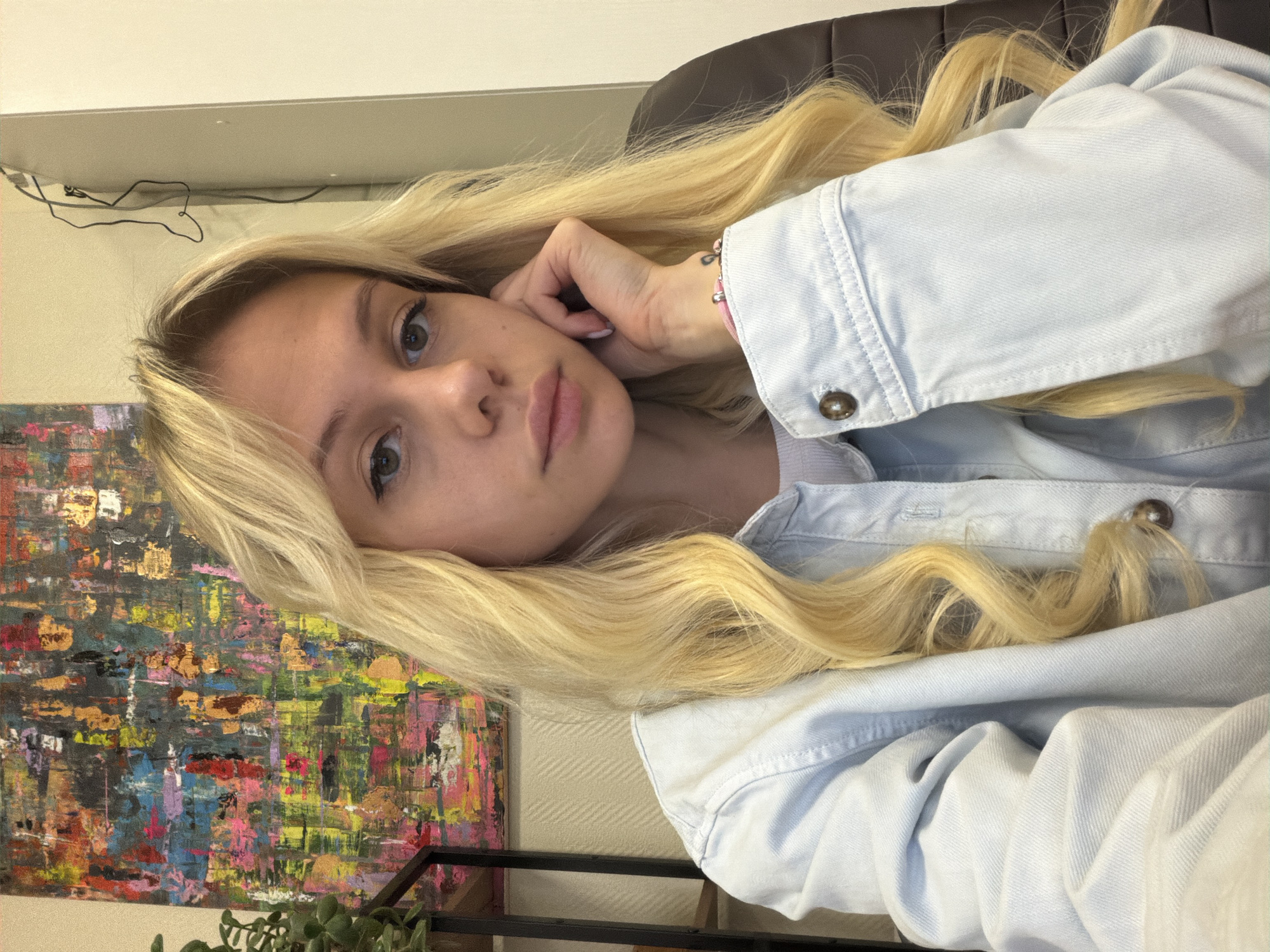 Portrait of blonde woman in denim jacket captured in Moscow