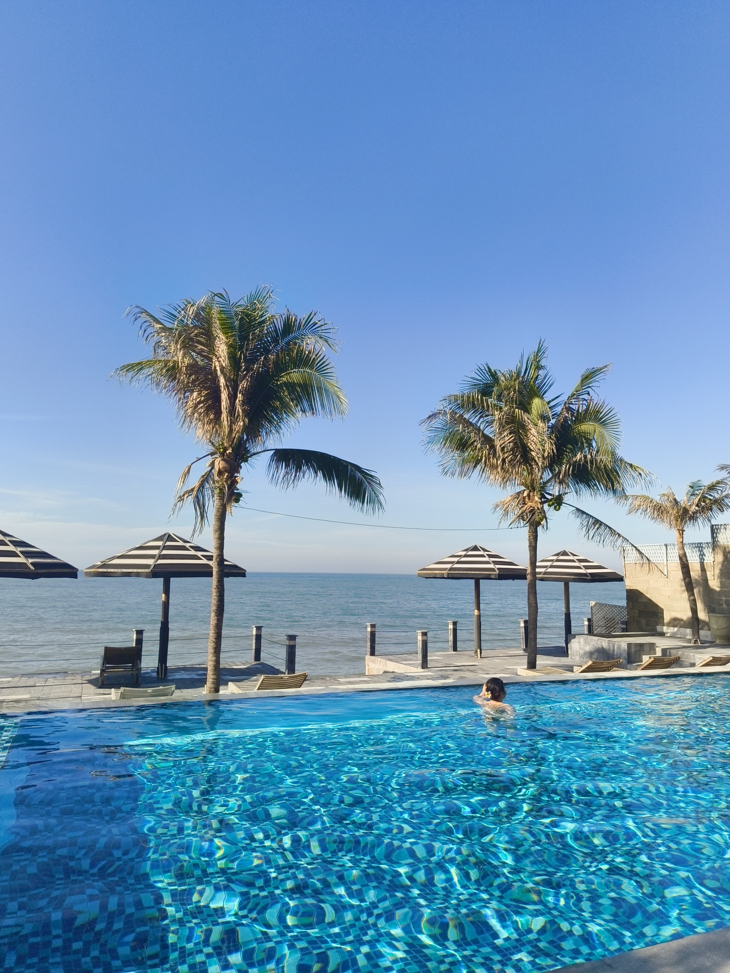 Lazy resort morning: pool, breakfast, and ocean views in Vietnam