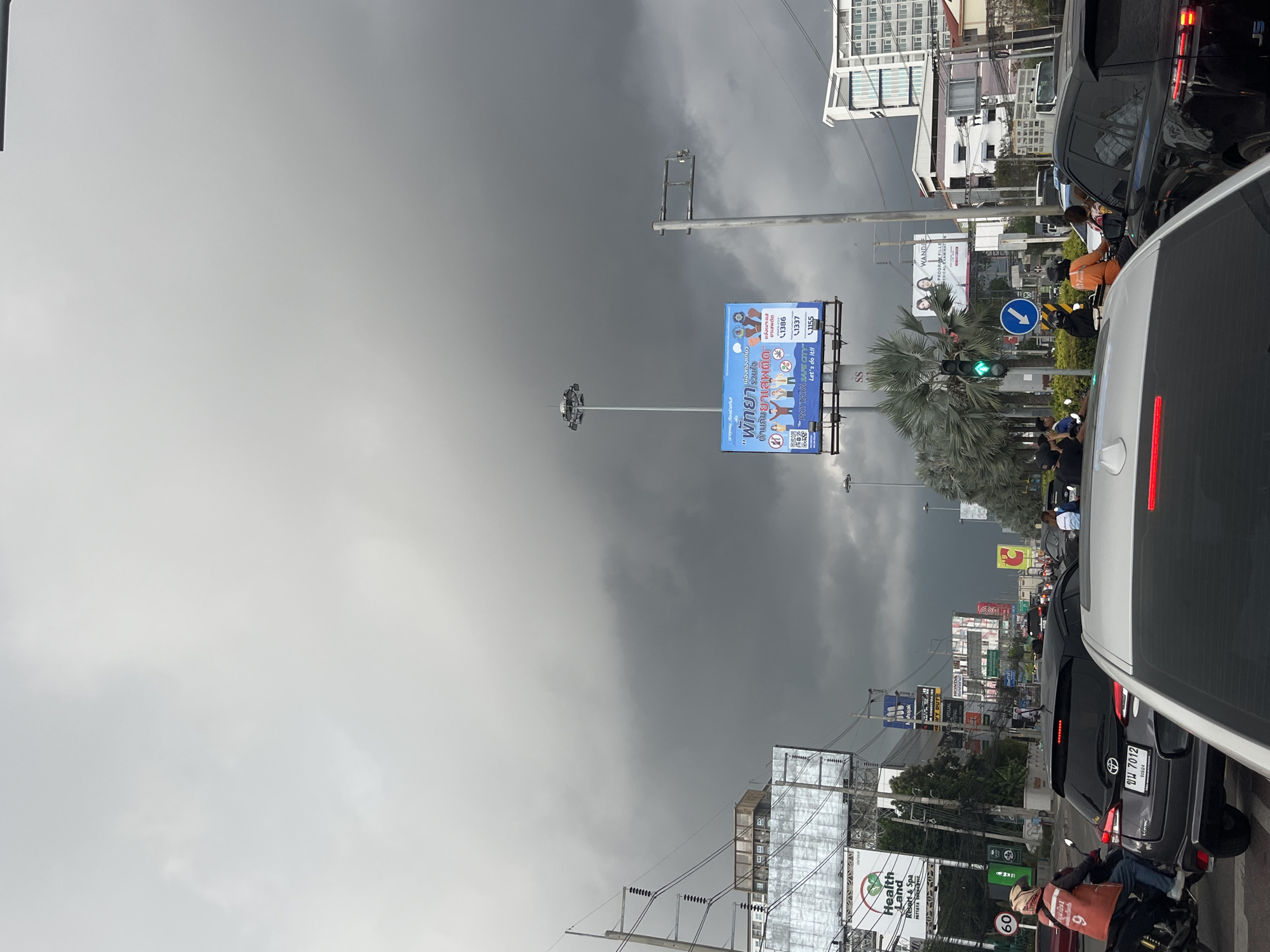 Morning traffic flows through Pattaya under cloudy skies