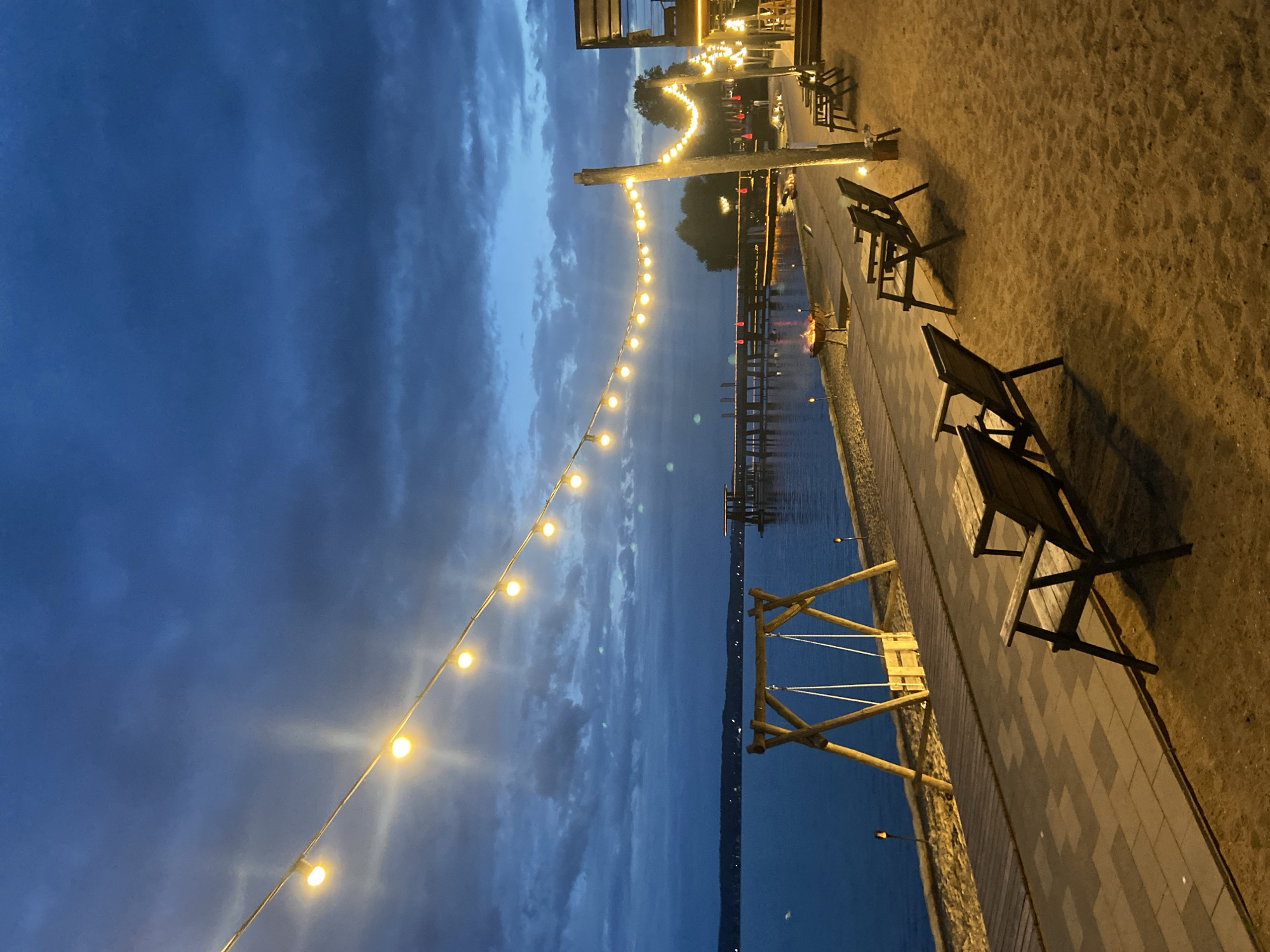 Lakeside venue at dusk, Votkinsk — fires, pods, and beach vibes