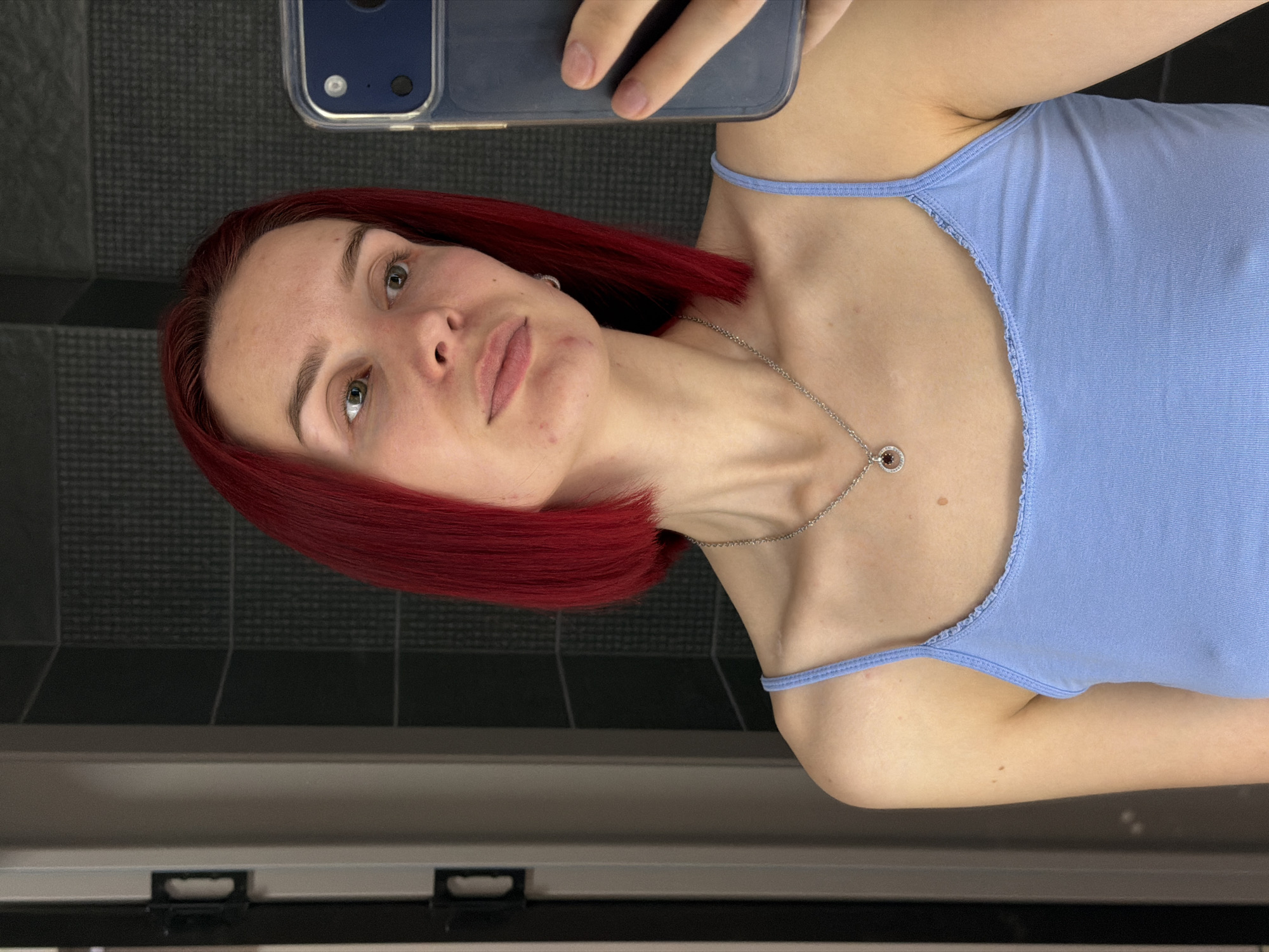 Woman takes selfies indoors in Chaikovsky, Russia