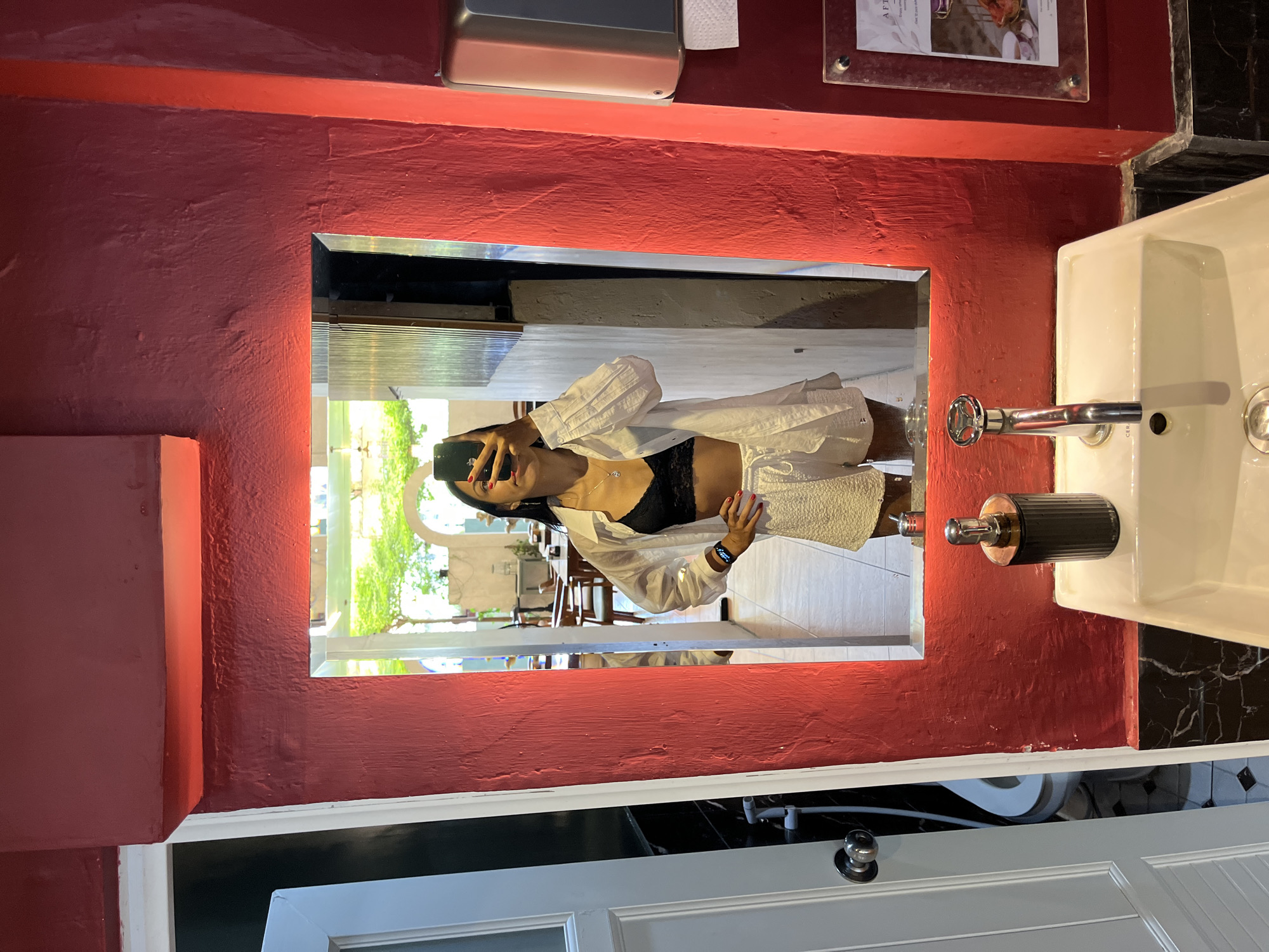 Women take bathroom mirror selfies in Kuta Selatan