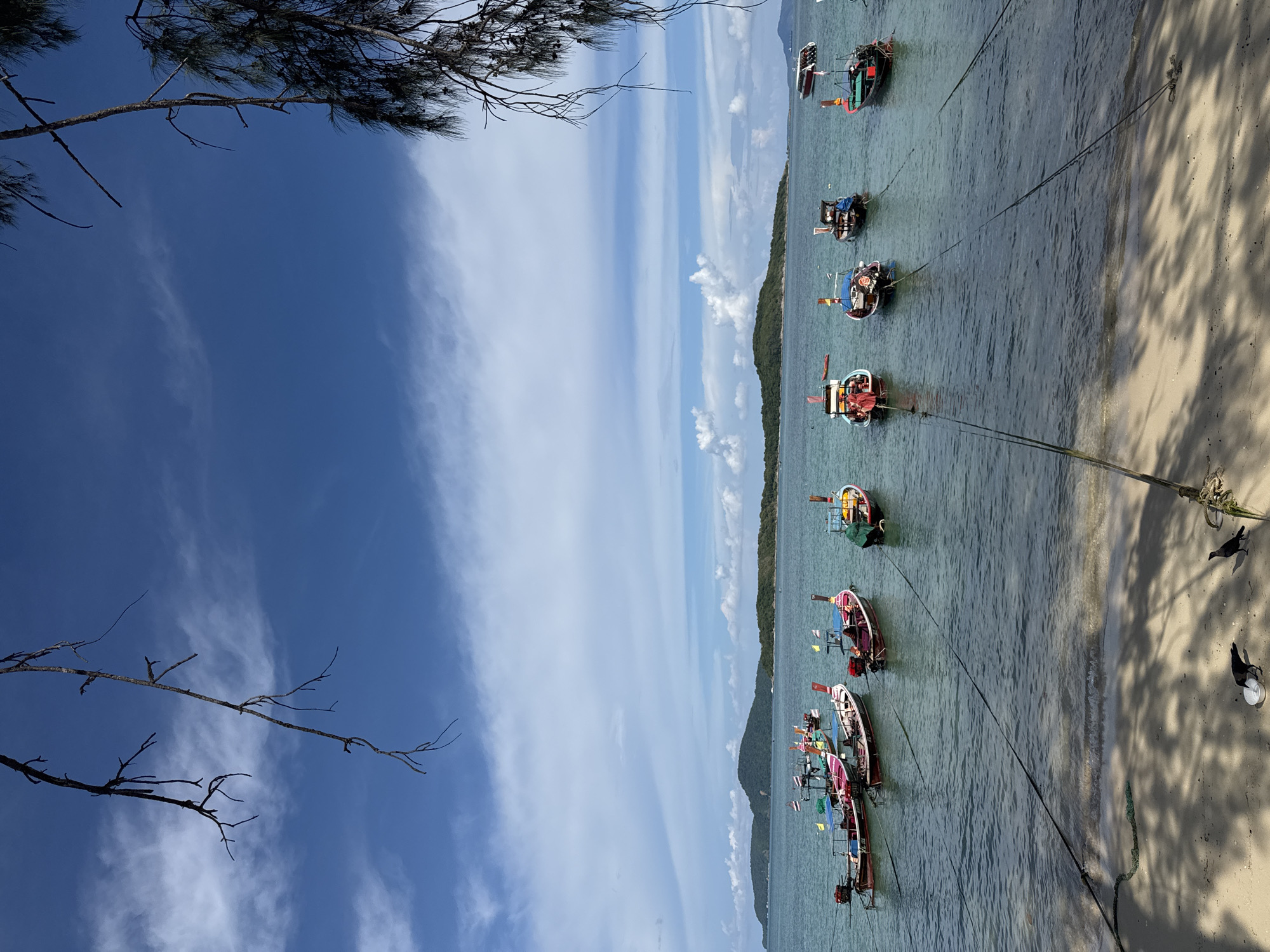 Longtail boats and shoreline stillness at Rawai Beach