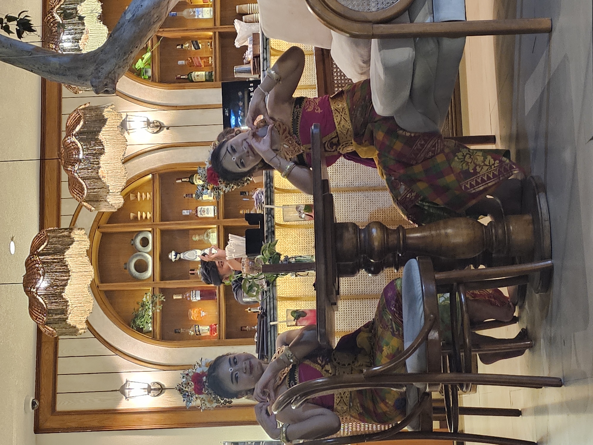Evening restaurant scene with traditional dress and live music in Denpasar