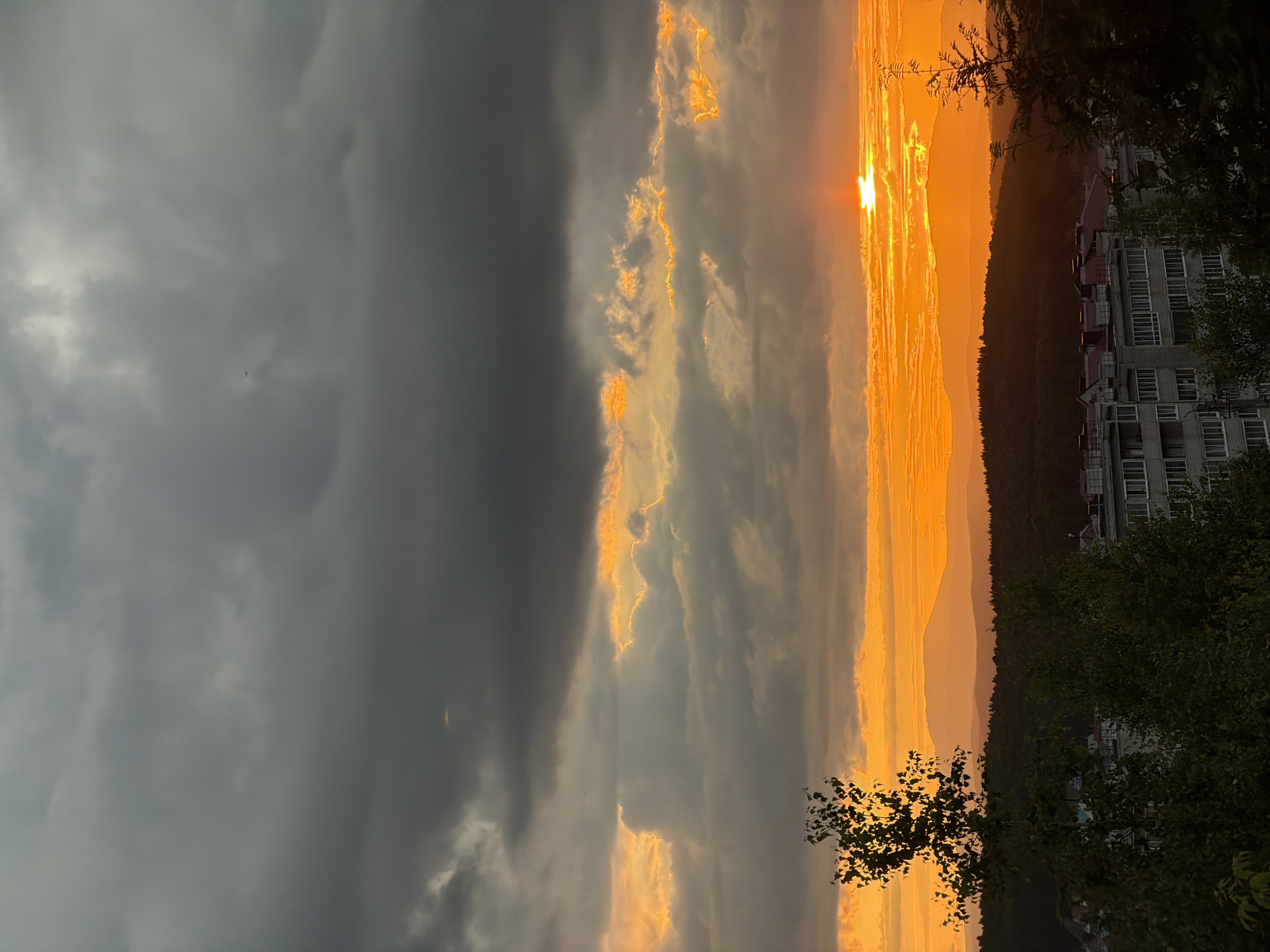 Dramatic sunset over a hilly city, caught from multiple angles
