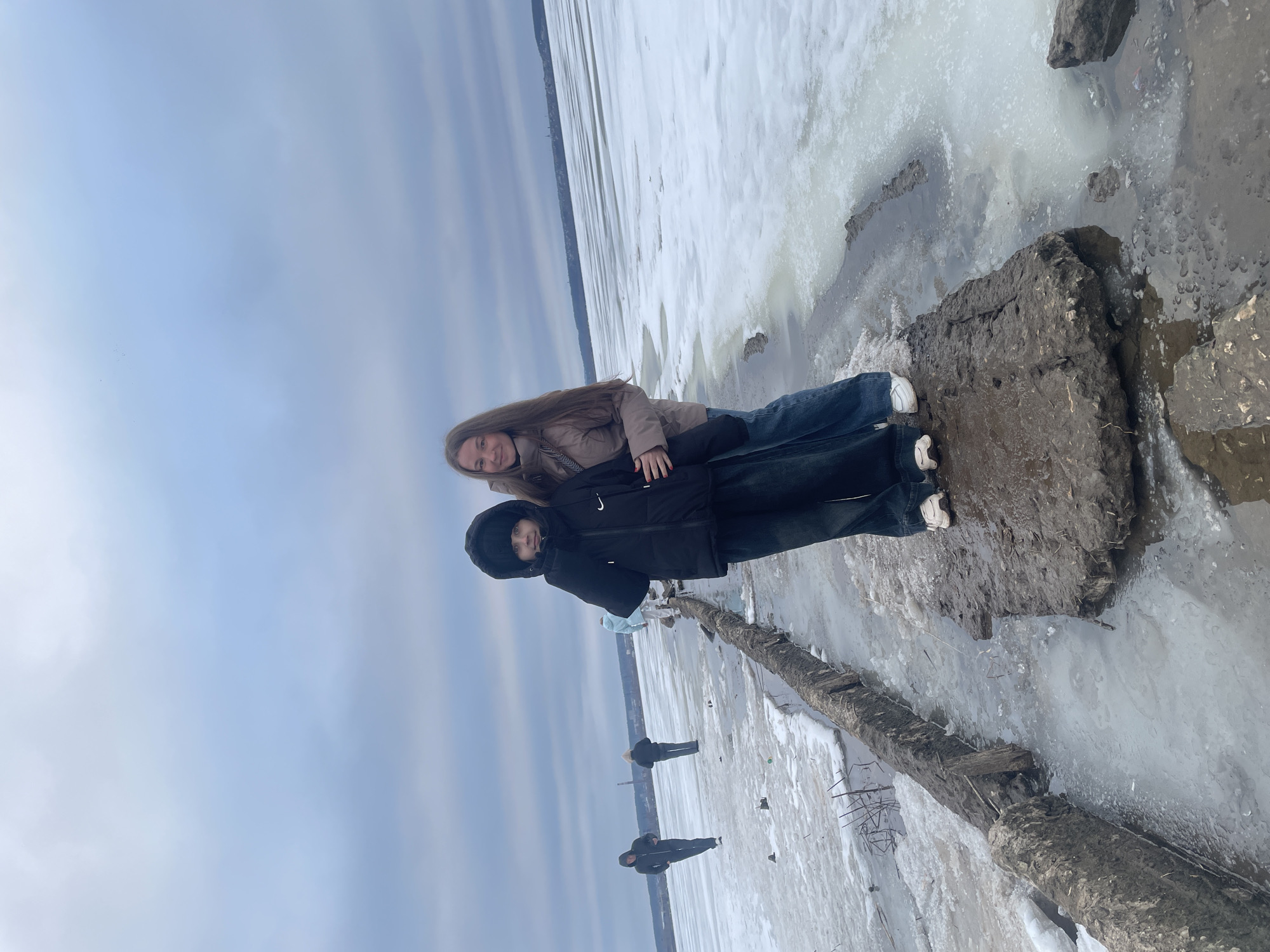 People pose on frozen waterfront in Izhevsk, Russia