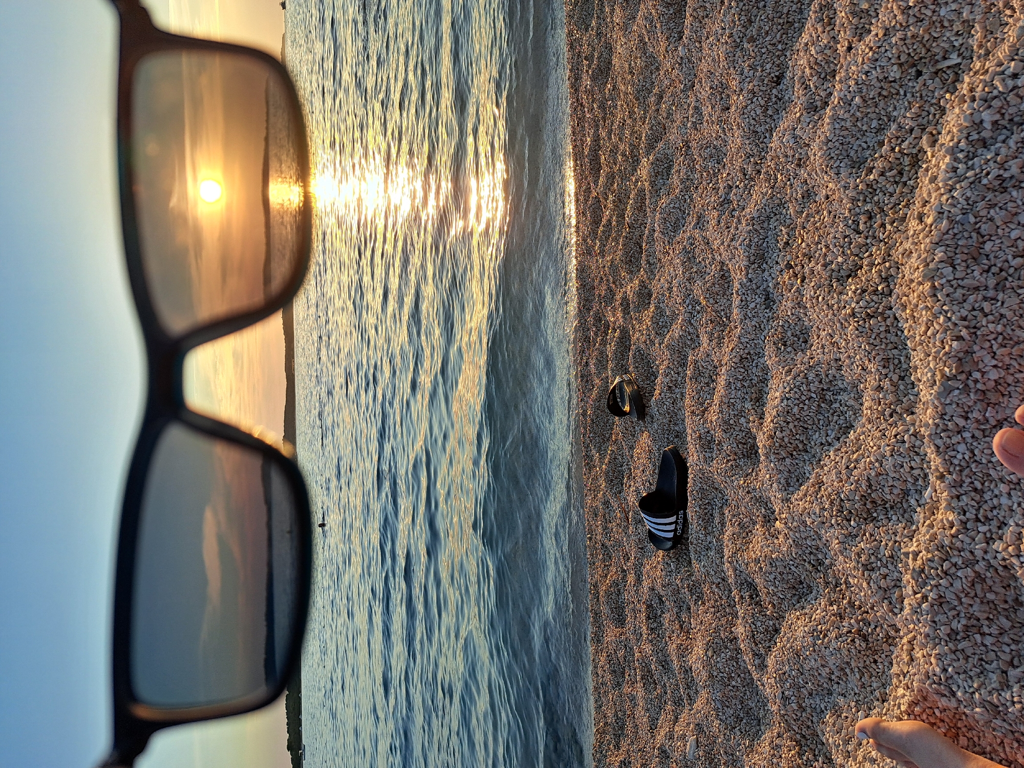 Golden hour on a pebble beach, sunset swims and shoreside chill