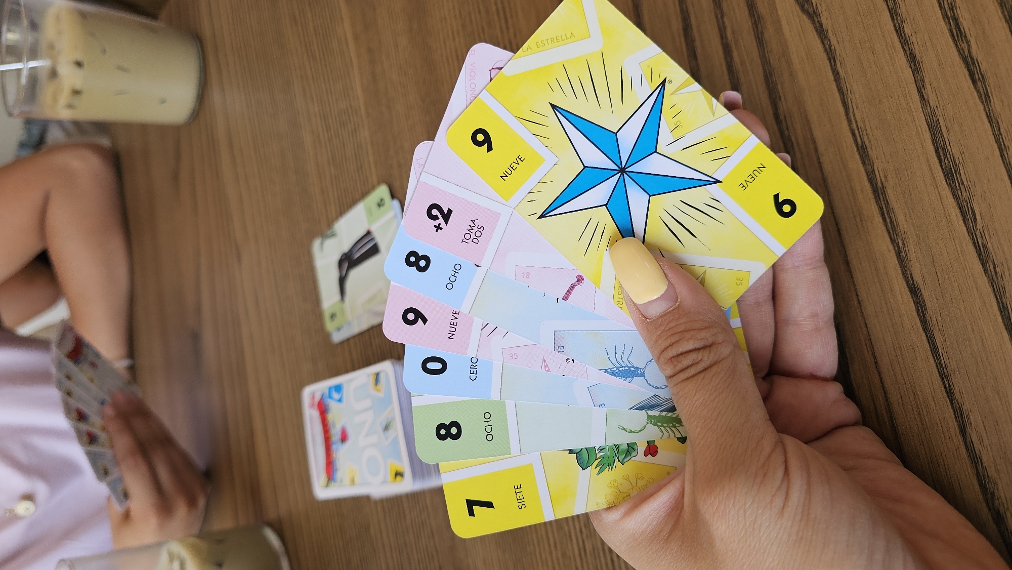 Friends play UNO Lotería at Mexican café with coffee