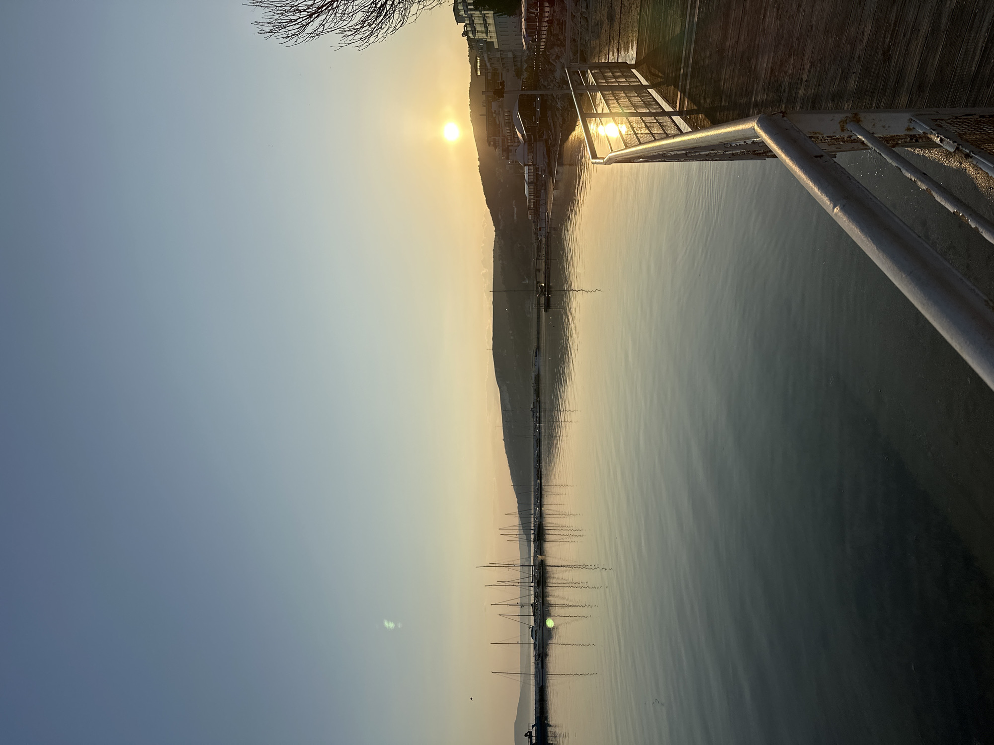 Sunset illuminates Balchik waterfront with moored sailboats
