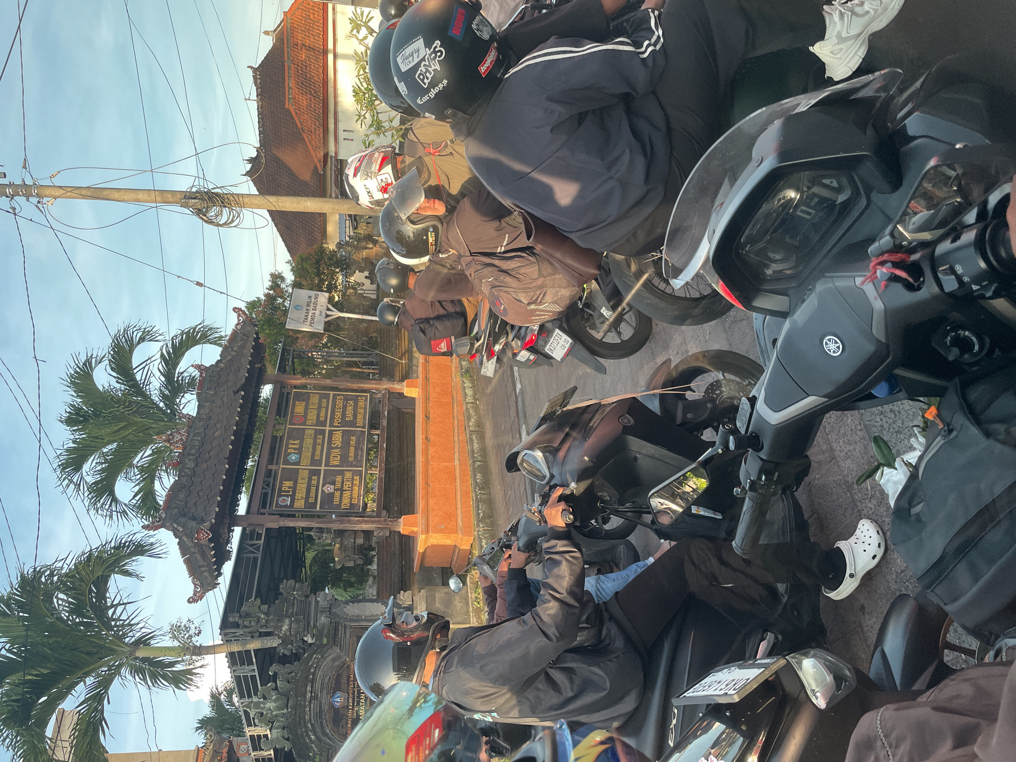 Motorcyclists wait at intersection in Mengwi, Bali