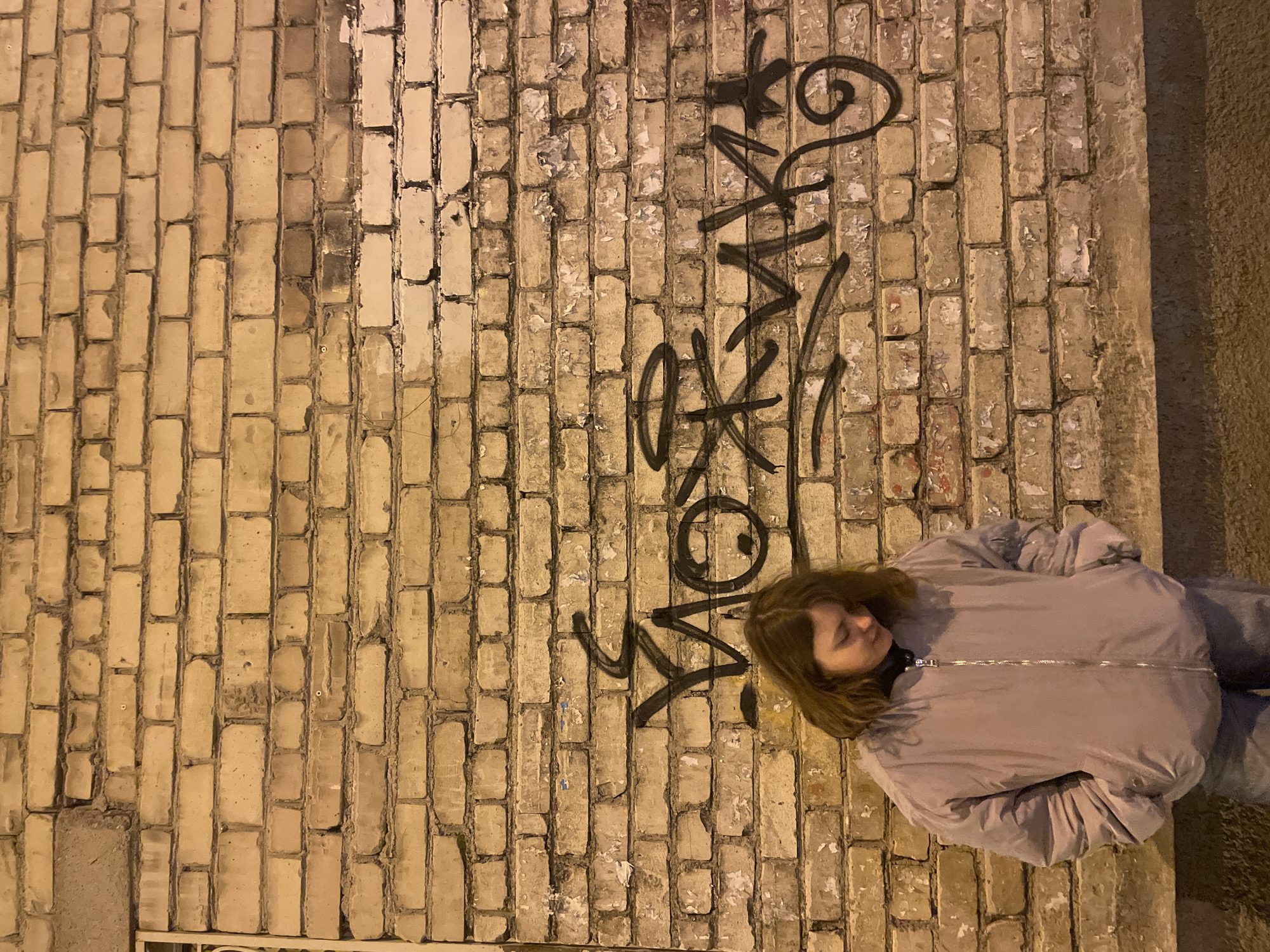 Woman photographed against graffiti wall in Yekaterinburg
