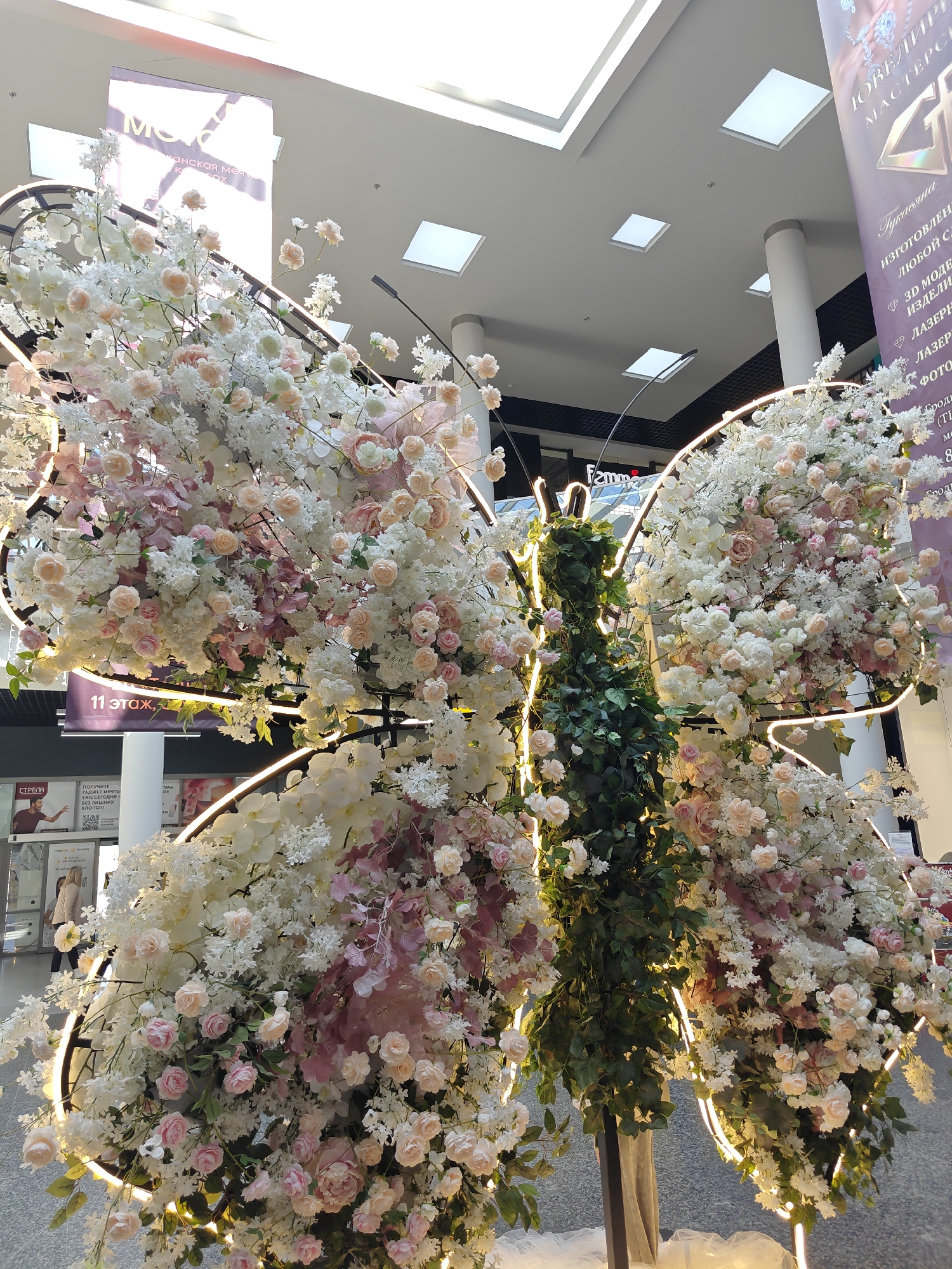 Ornate floral butterfly installation observed with lights and decorations