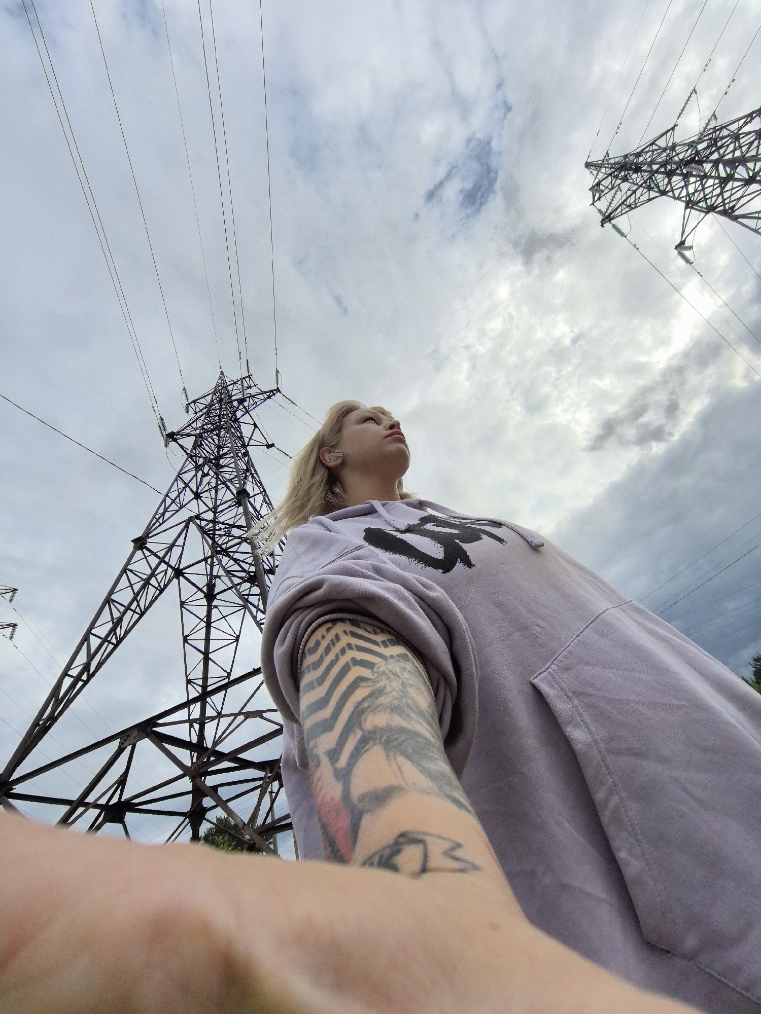 Woman photographs herself beneath power tower in rural Russia