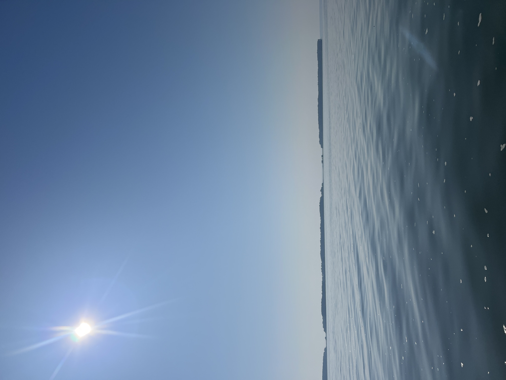 Fishing a calm Siberian lake on a bright summer morning