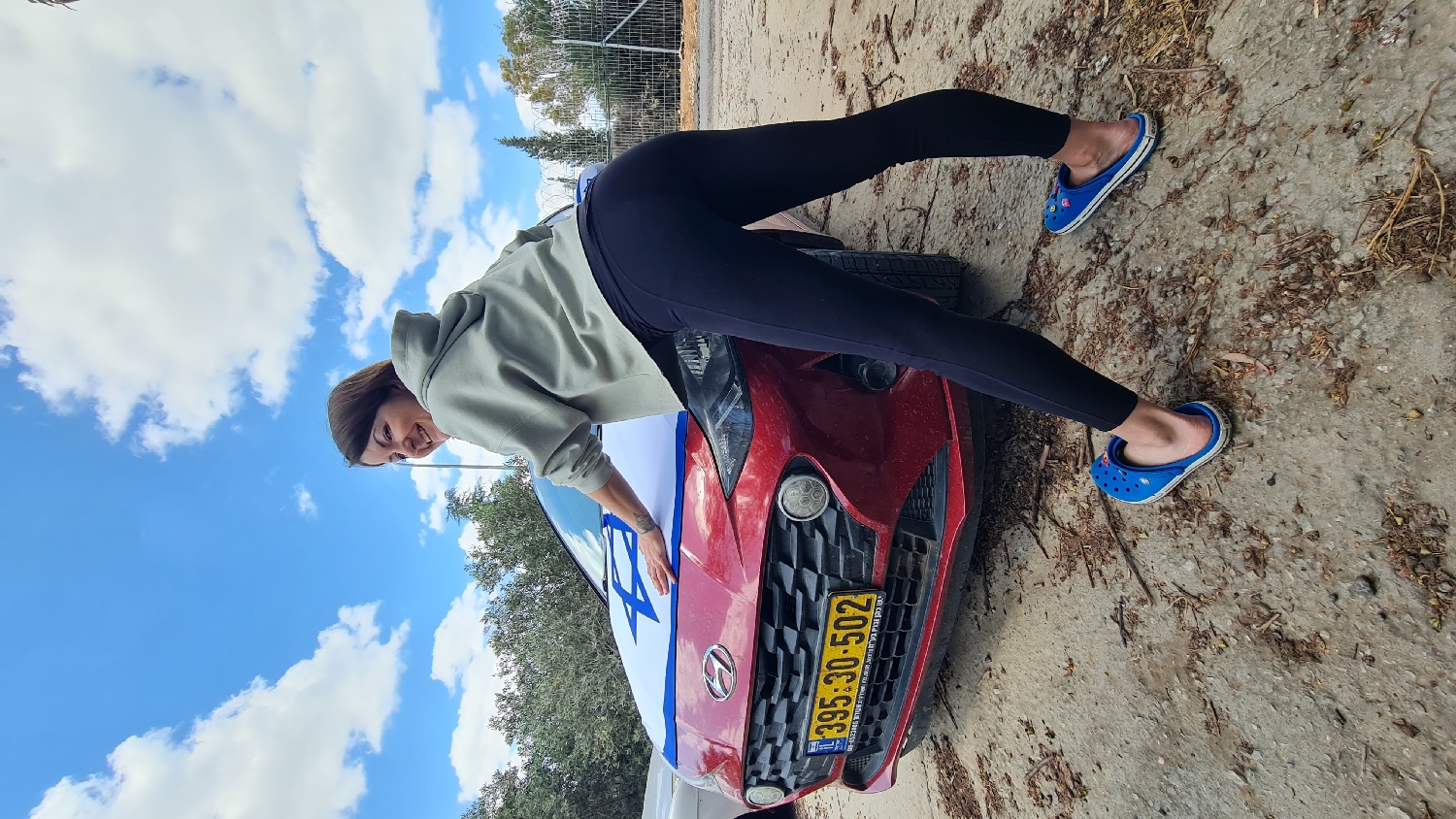 Woman poses with flag-decorated car, aquarium fish photographed