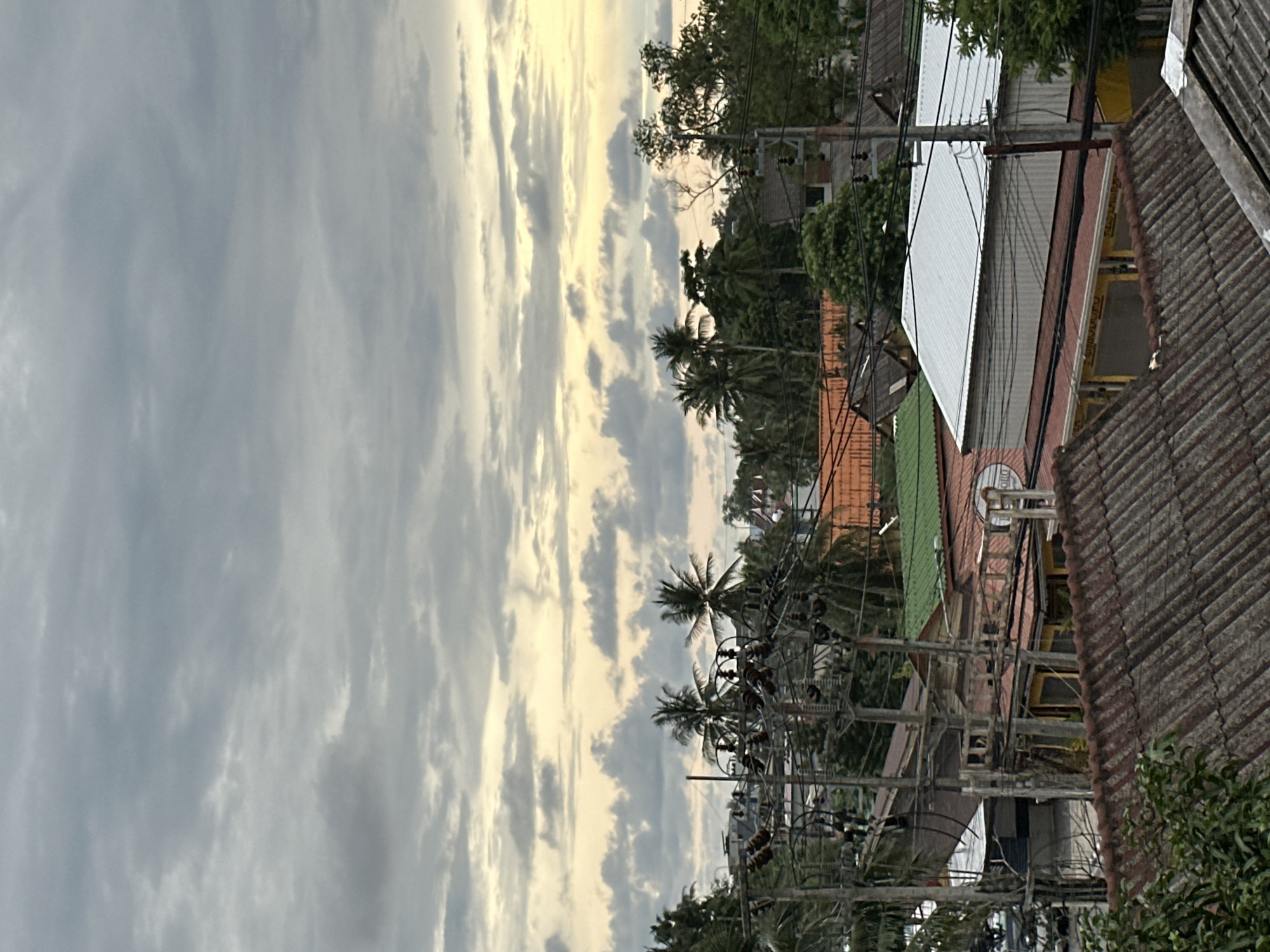 Overcast morning in Karon — rooftops, street life, and slow downtime