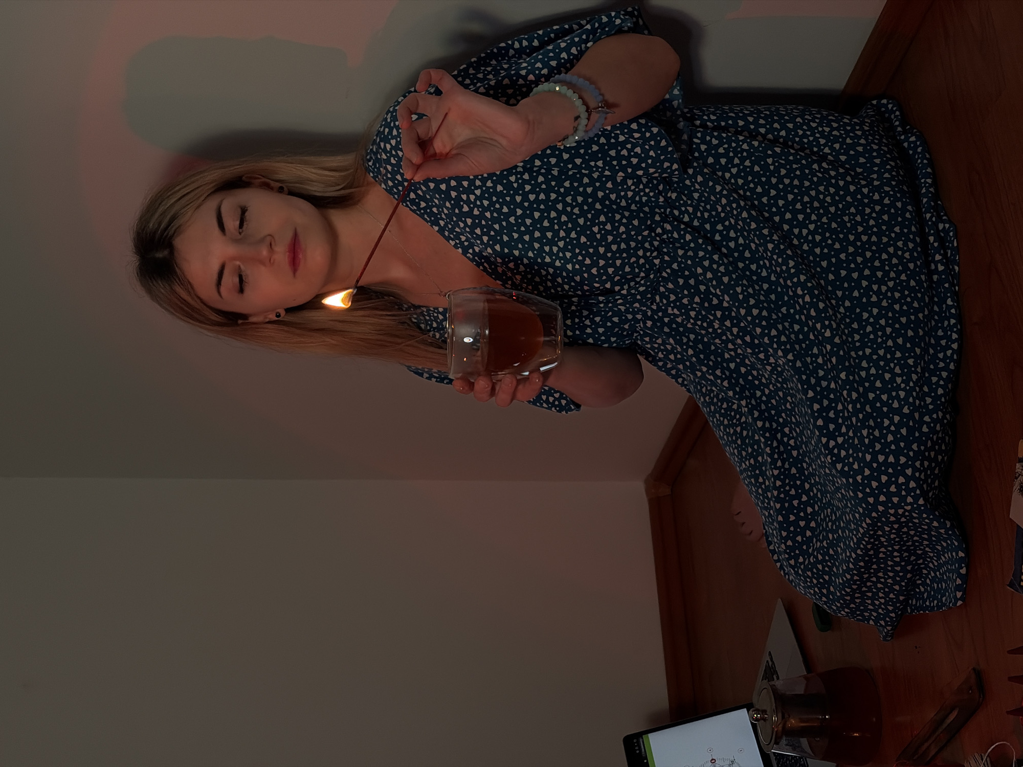 Woman conducts evening tarot reading ritual in Budva corner room
