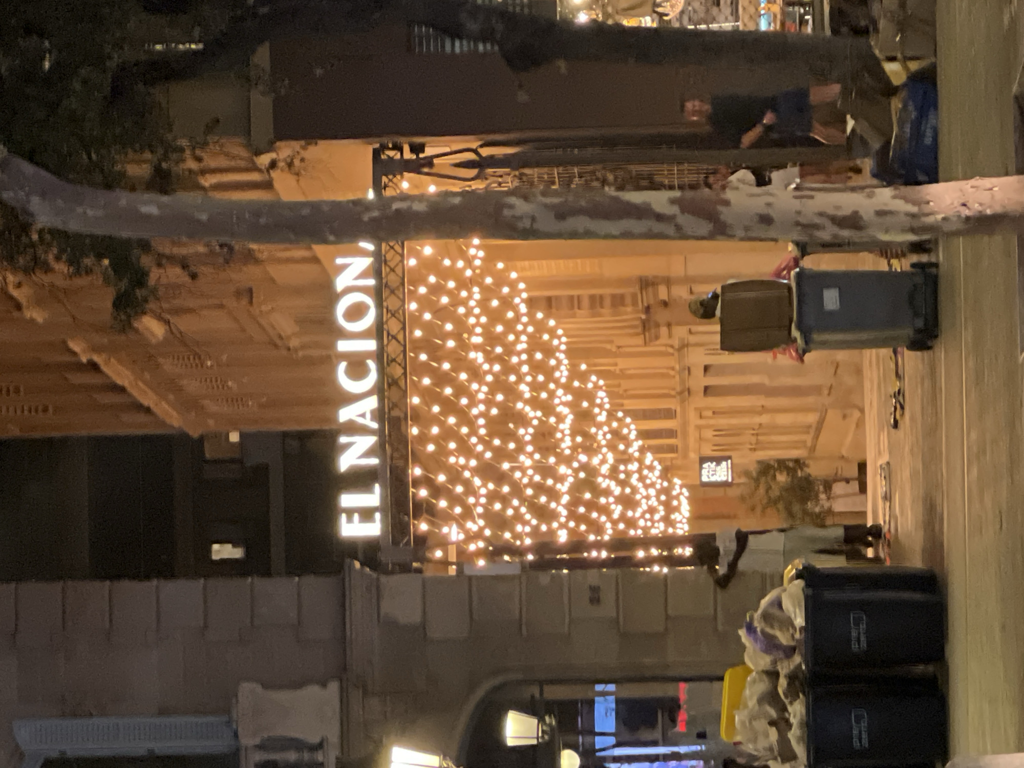 Christmas lights illuminate Barcelona street scene at night