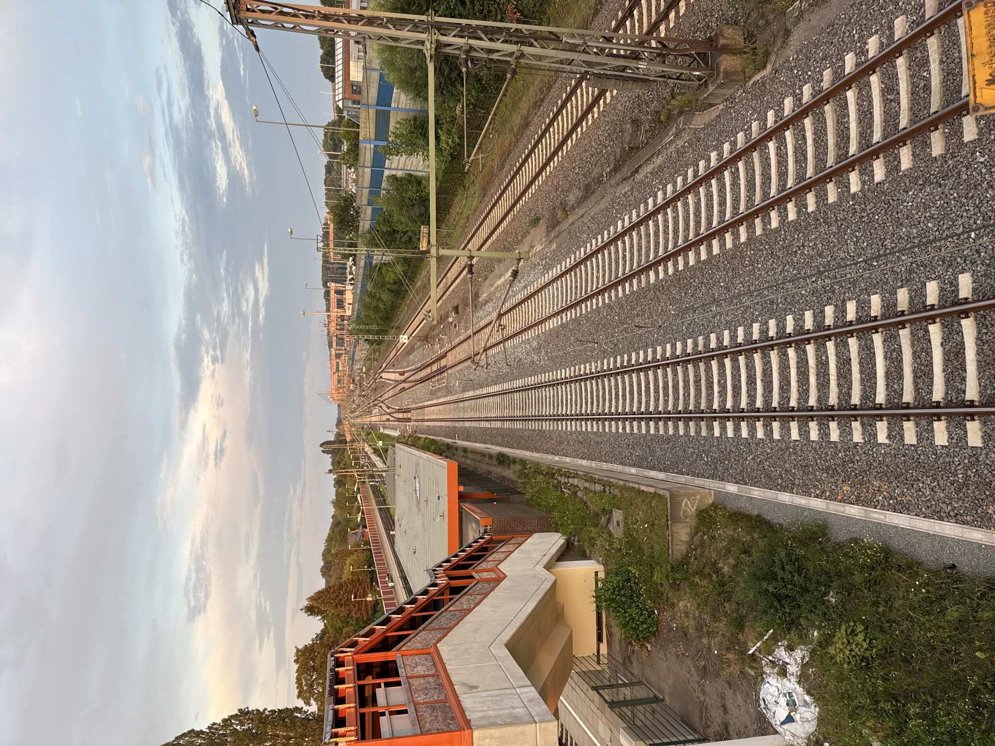 Railway tracks at golden hour, ground to aerial.