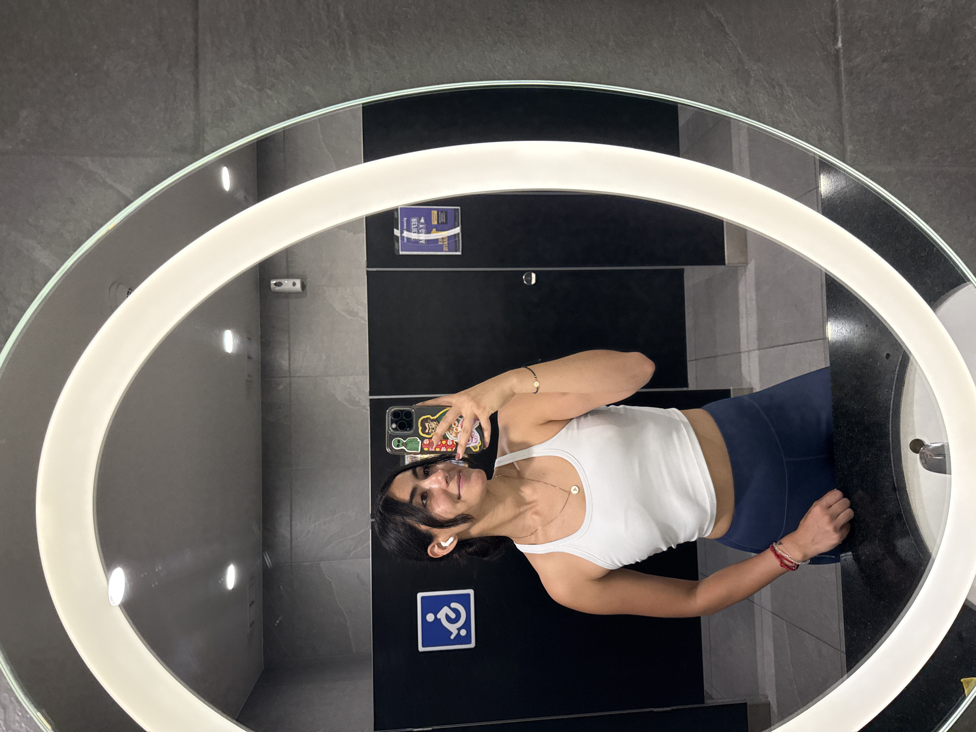 Woman takes selfie in Puebla restroom mirror