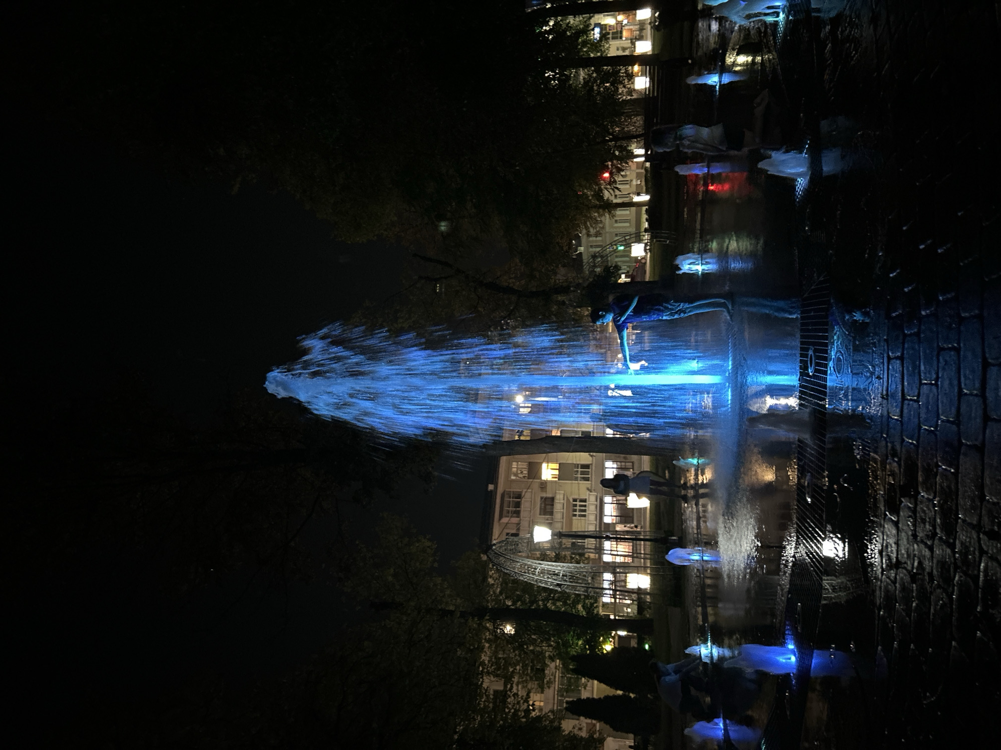 Illuminated fountain display in a Homyel public square at night