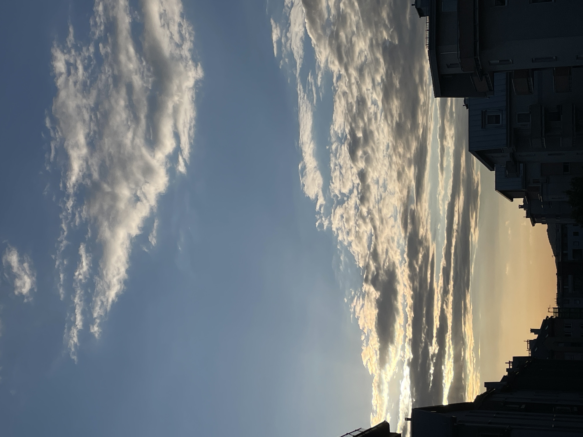 Urban sunset captured between buildings creates dramatic sky display