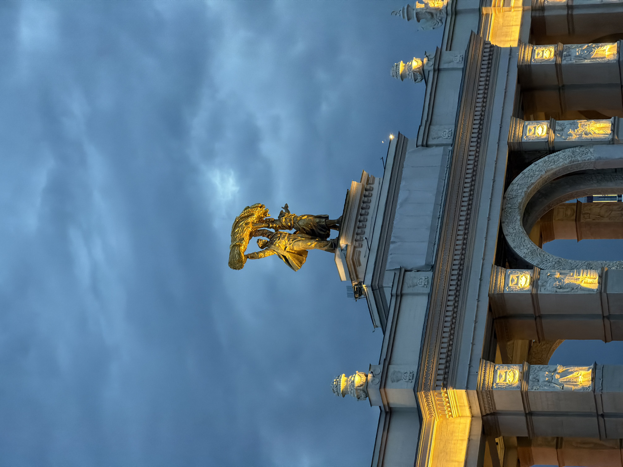 Golden-lit Soviet statue documented at Moscow's VDNKh entrance