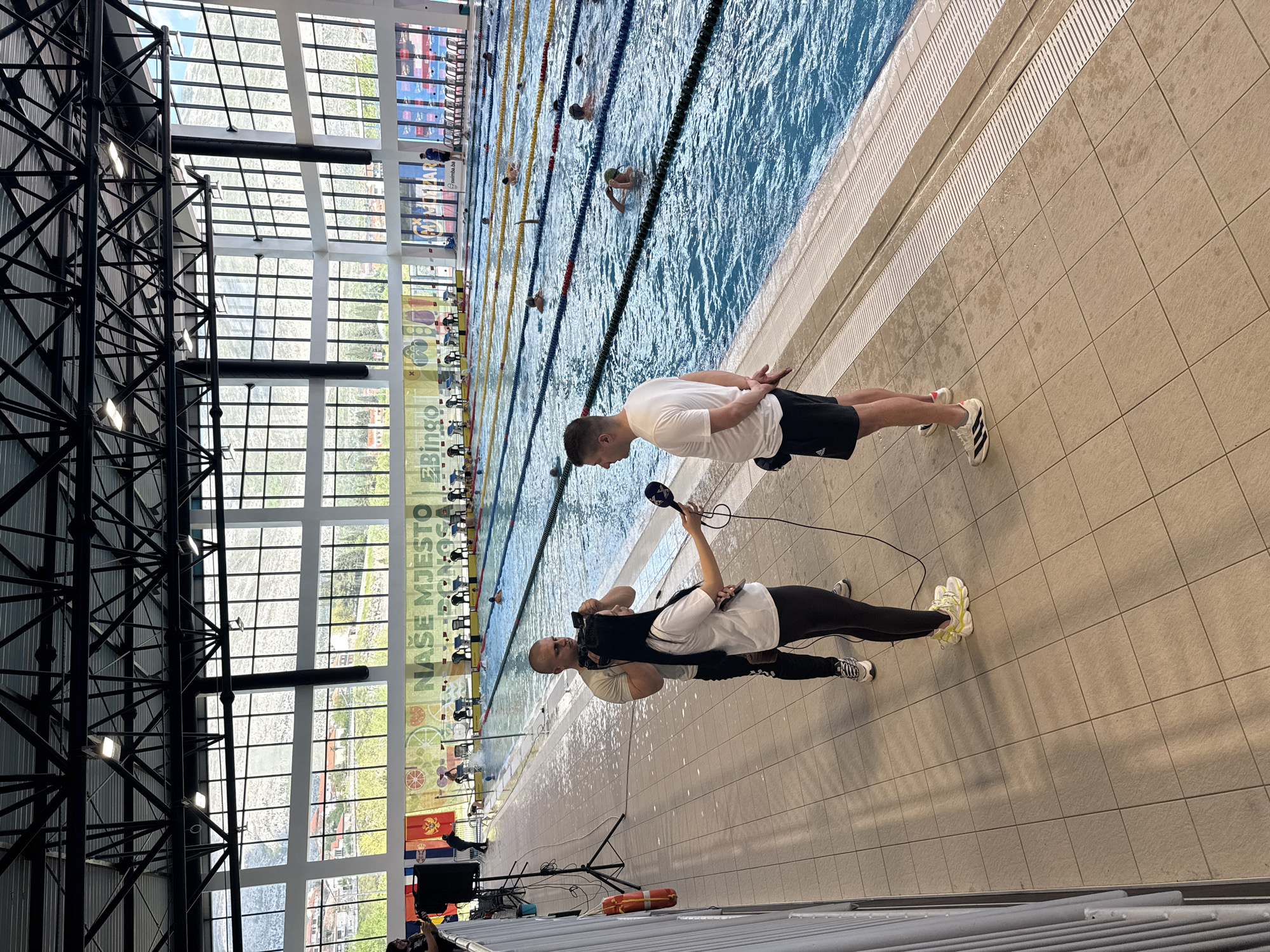 Reporter interviews subject at Trebinje Olympic Pool facility