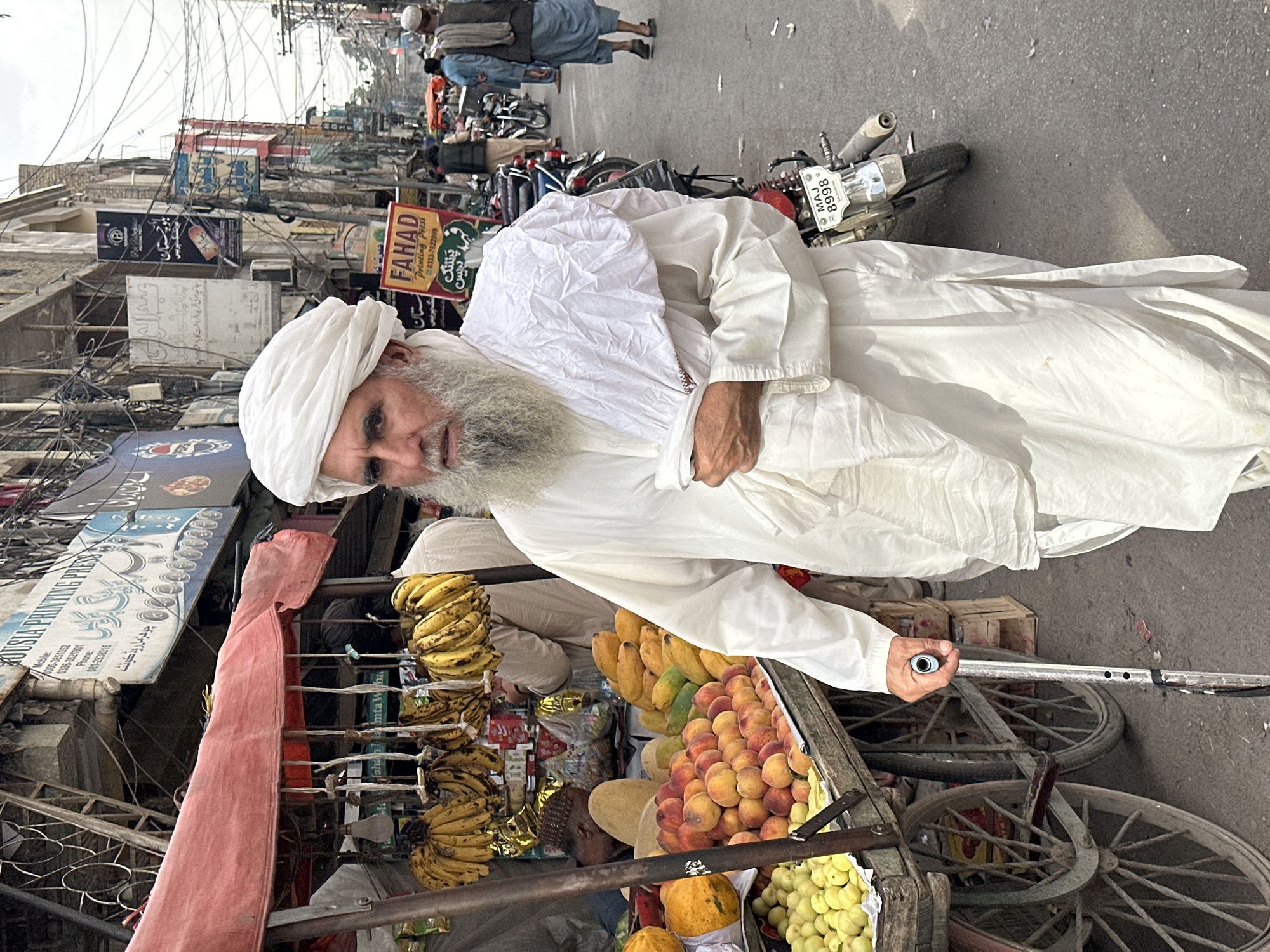 Elderly vendor conducts daily business on Quetta streets