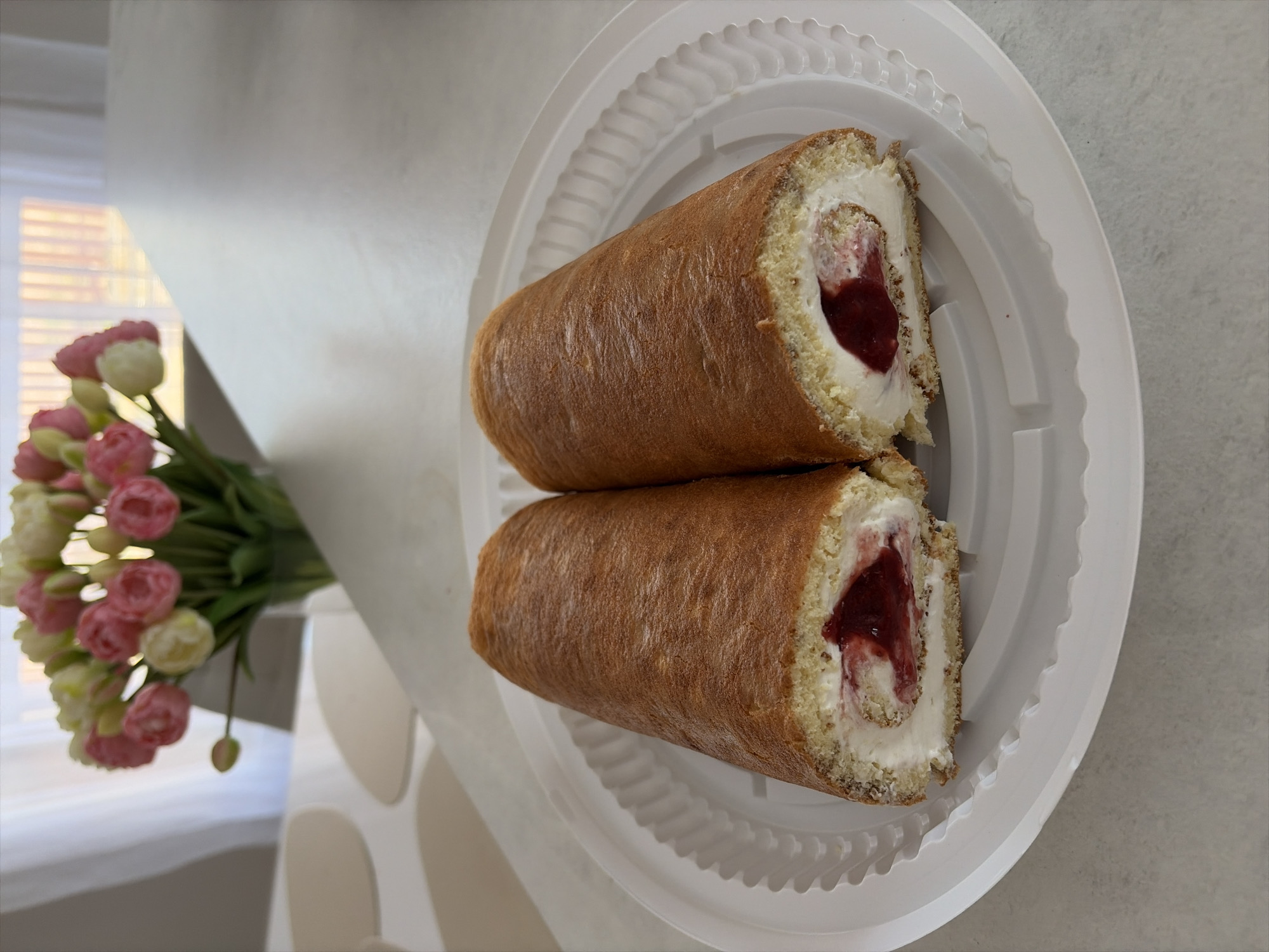Swiss roll cake slices documented on white plate