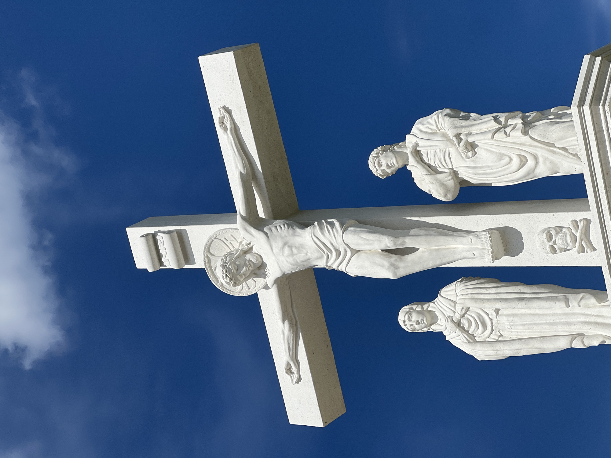 Crucifixion monument and summer blooms in Rezina, Moldova