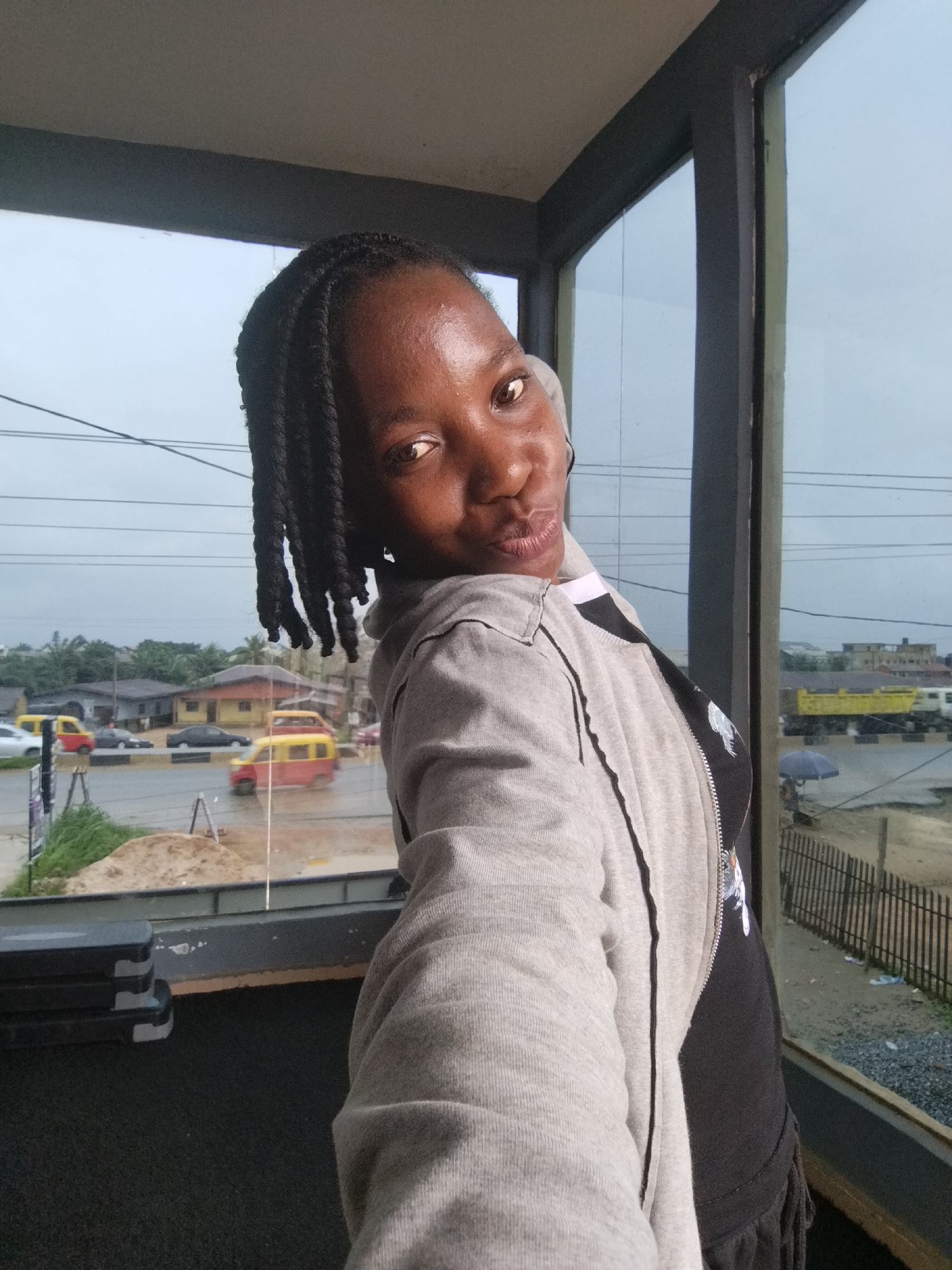 Casual selfie session in a Uselu building on a rainy afternoon