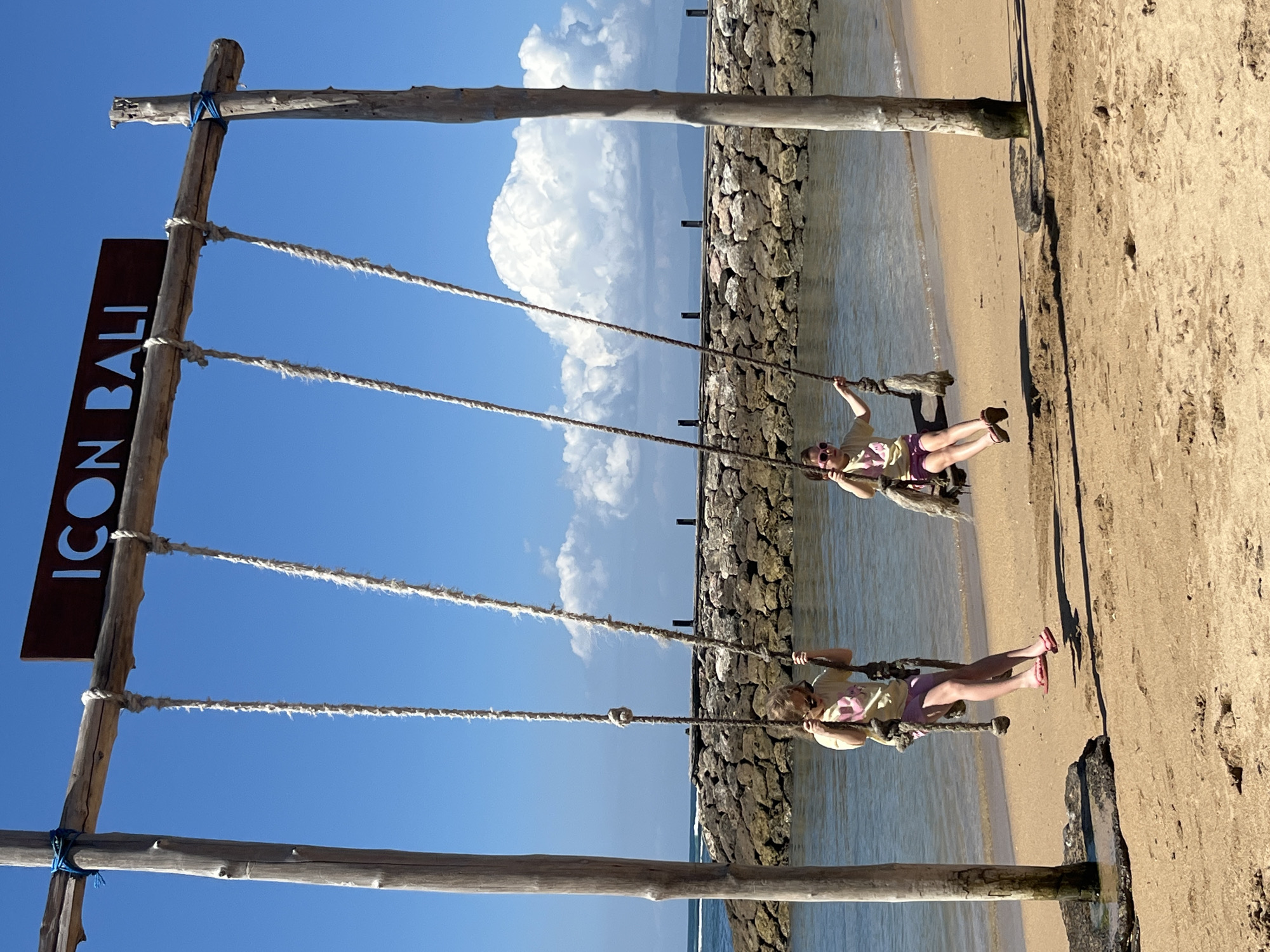 Wooden beach swings over the ocean near Denpasar, Bali
