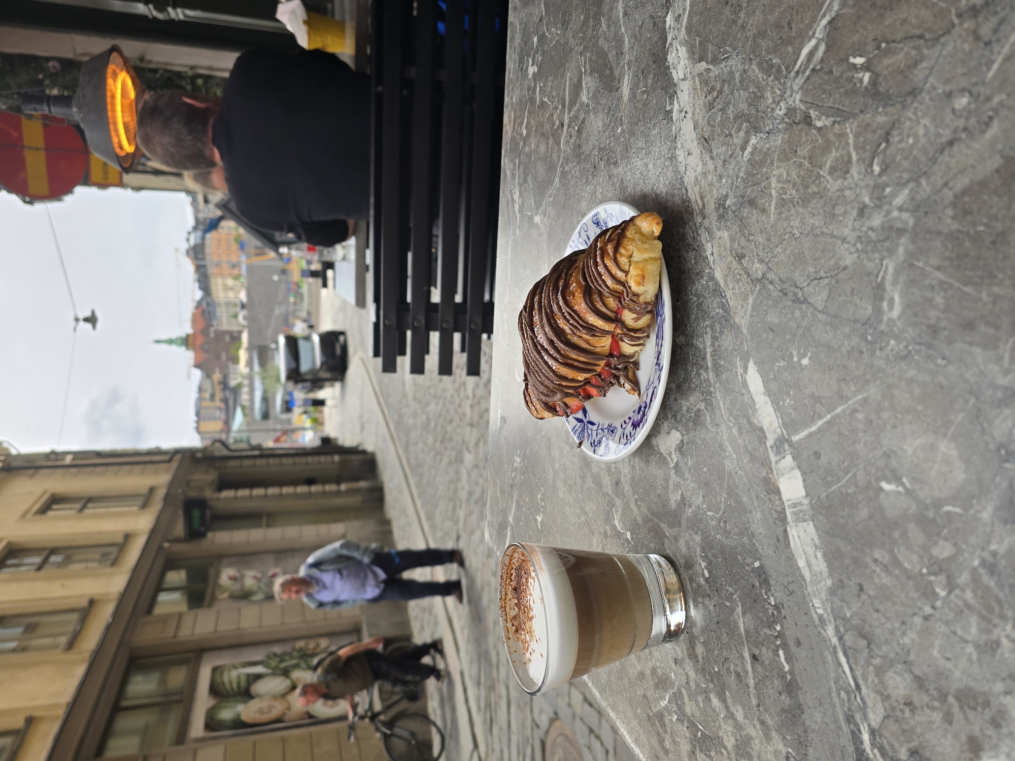Visitor documents Stockholm's historic center during afternoon walkabout