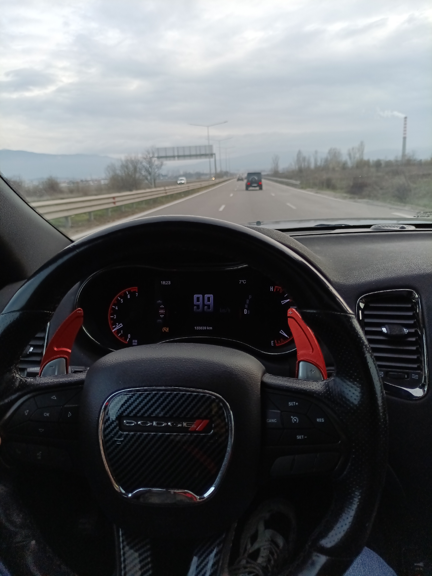 Driver travels Bulgarian highway in Dodge vehicle with sporty interior
