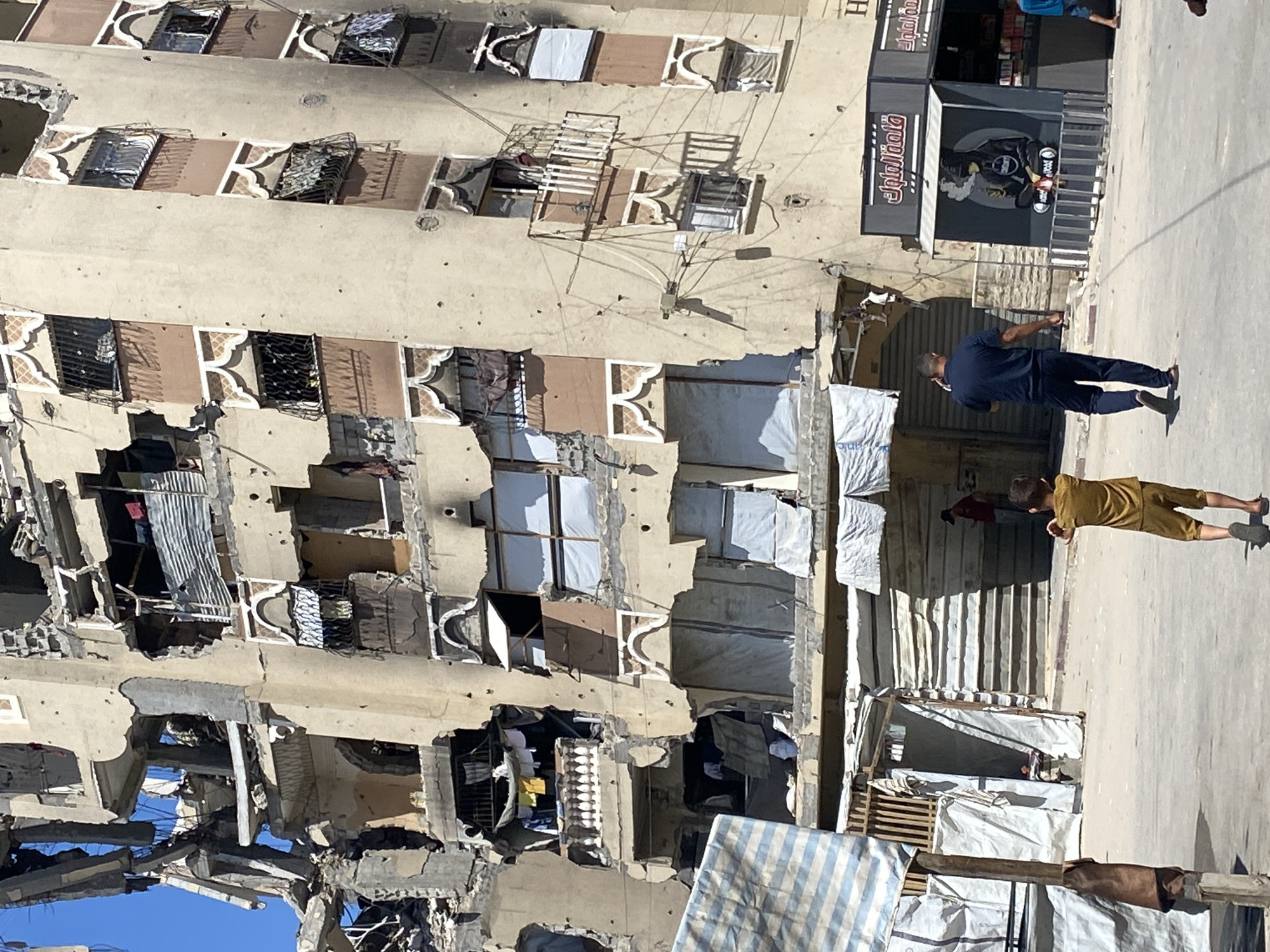 Damaged buildings and active commerce documented in Khan Yunis