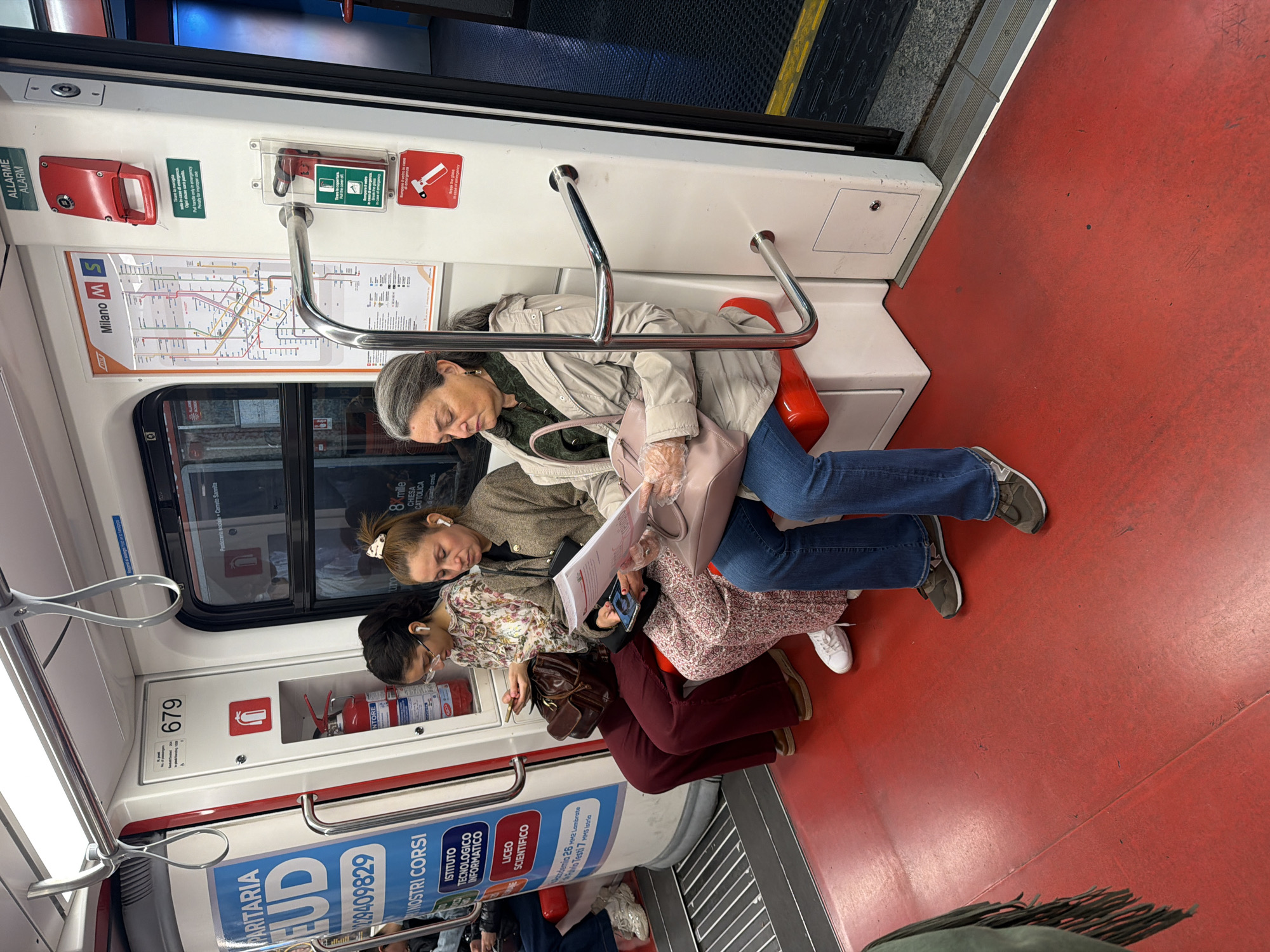 Three women ride Milan metro train together