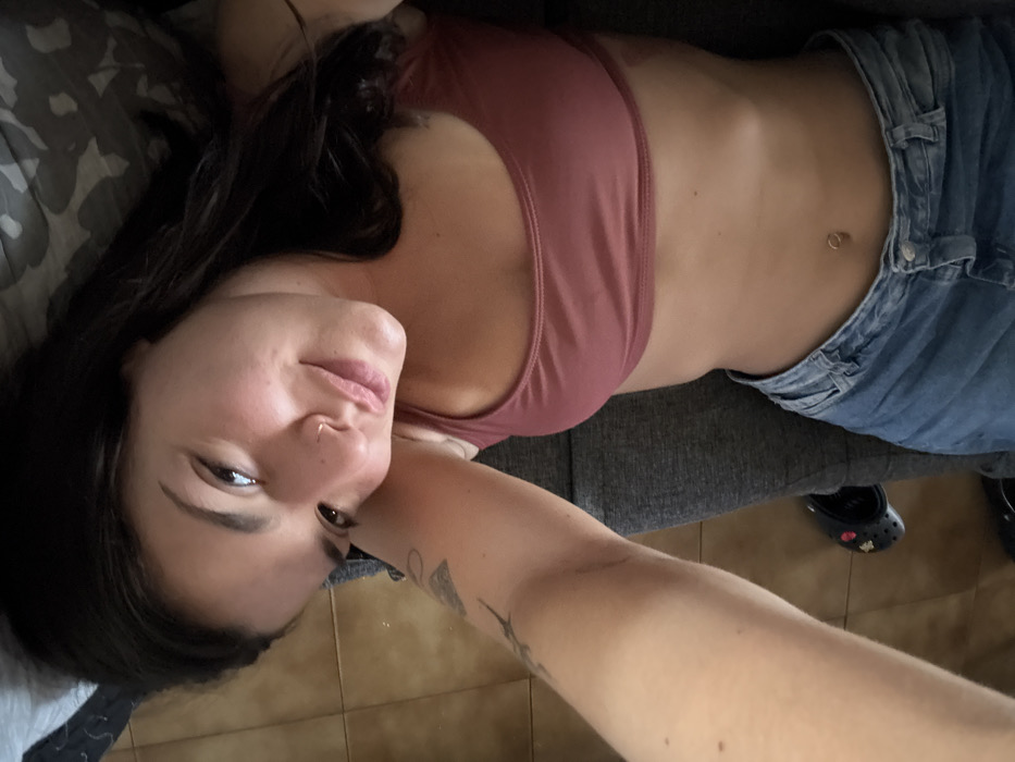 Woman relaxes at home, enjoys iced coffee indoors
