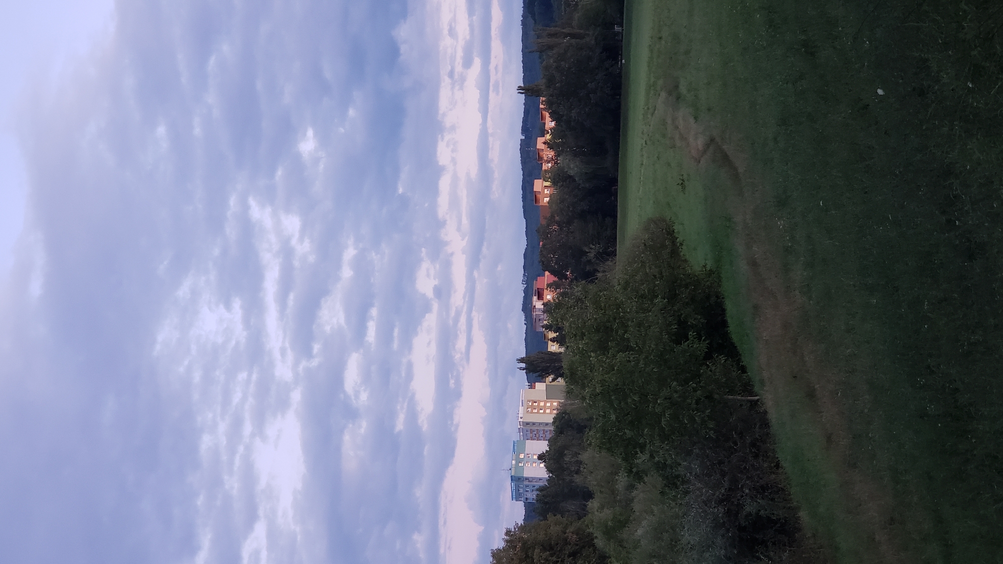 Prešov at dusk: riverside park and apartment blocks