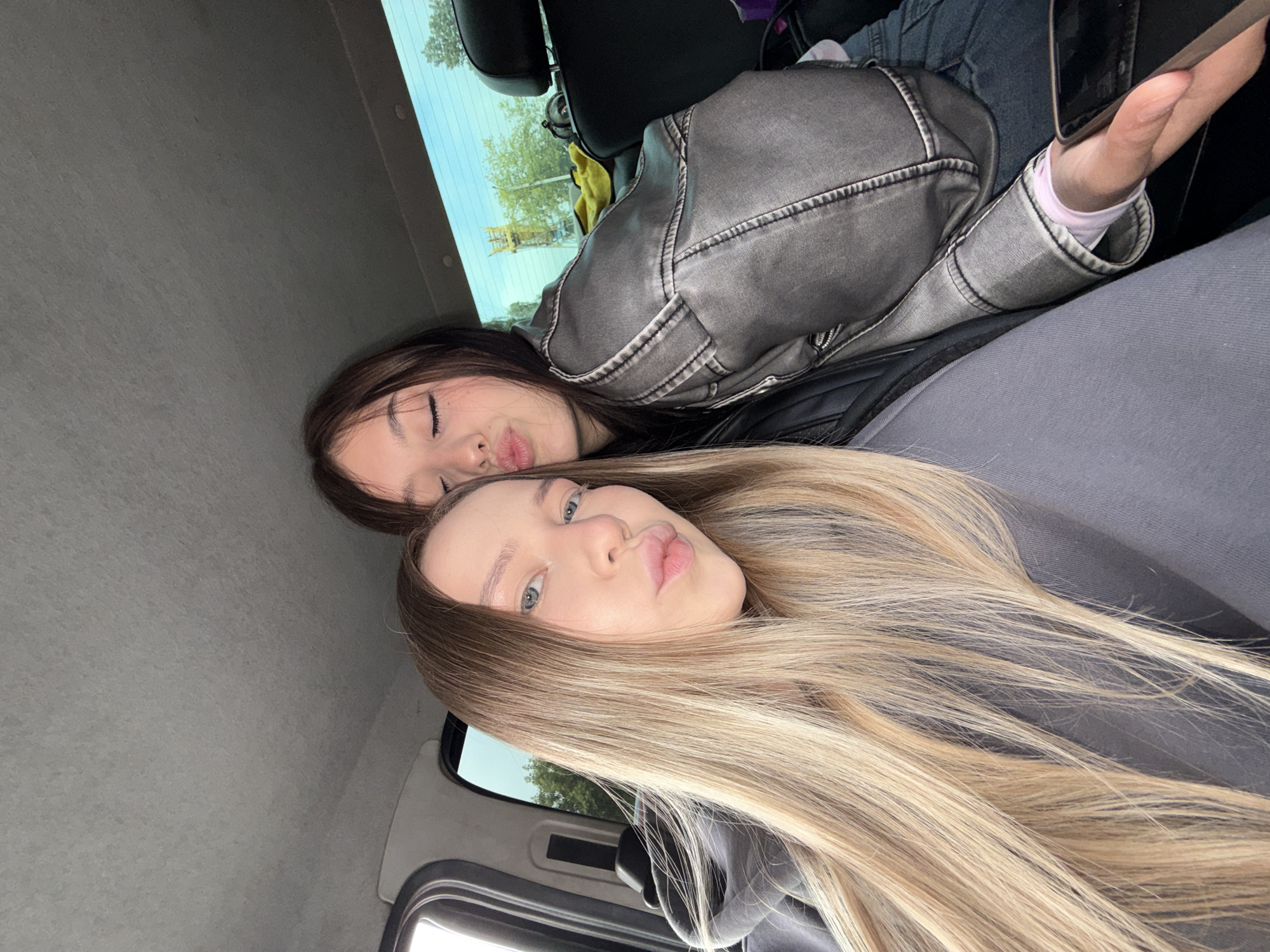 Young women take playful selfies, eat strawberries in Chaikovsky