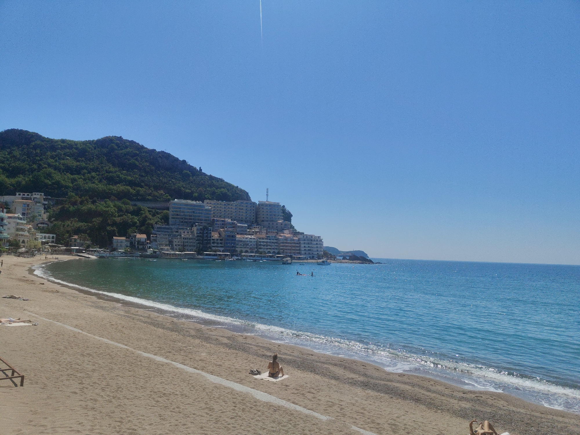 Sunny day beach relaxation captured in Rafailovići, Montenegro