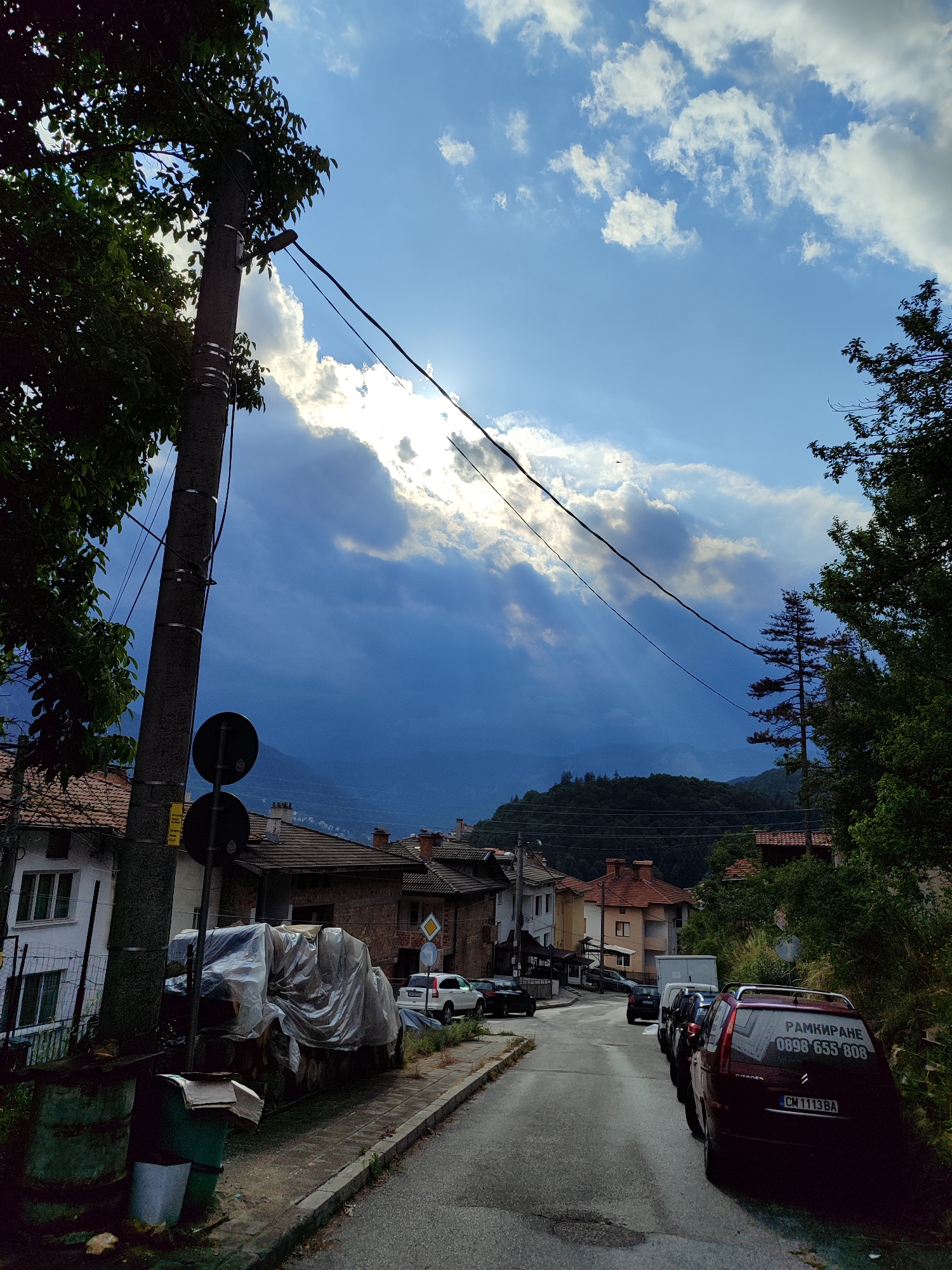 Red helicopter over Smolyan's mountain forests on a cloudy day
