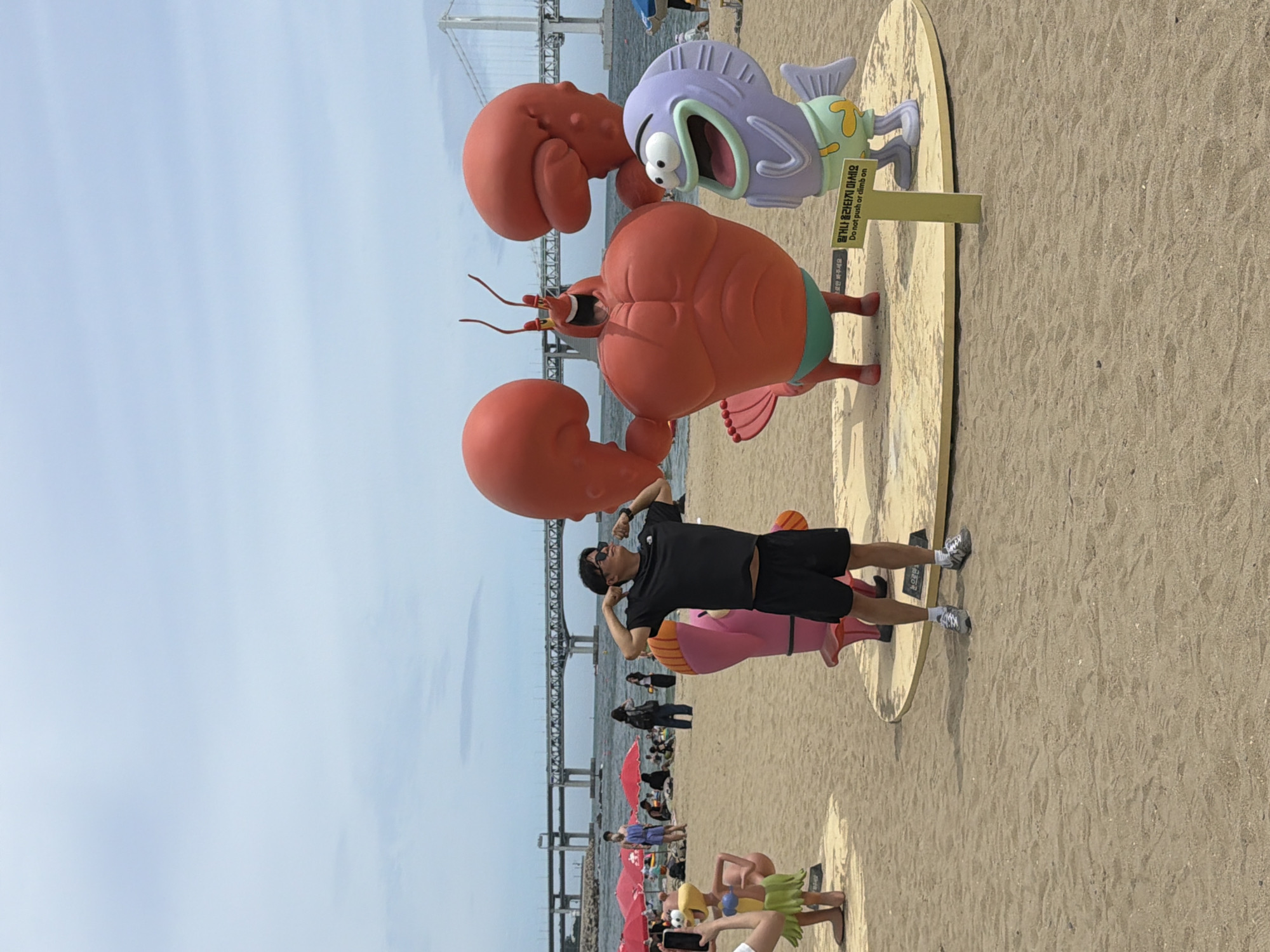 Haeundae Beach fun: flexing, inflatables, and bridge views
