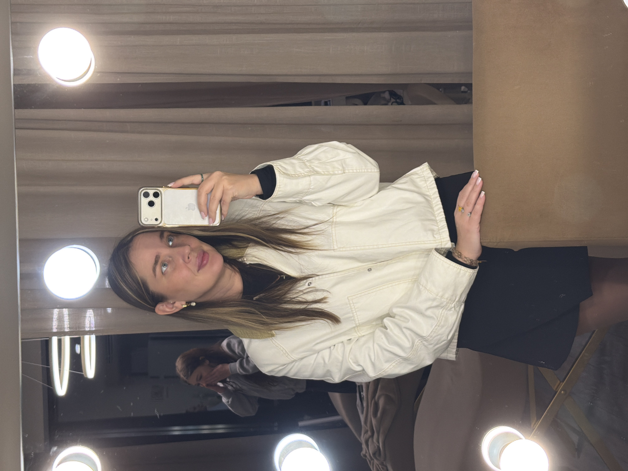 Woman takes selfie in lighted mirror in Moscow