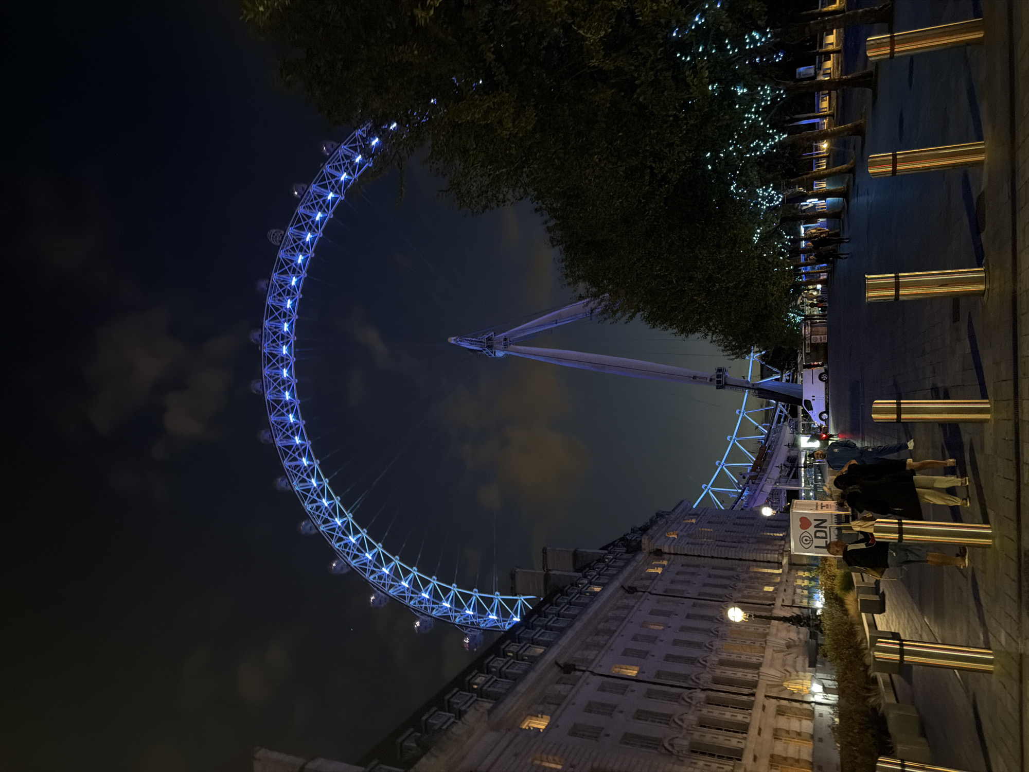 London Eye glowing blue on a quiet summer night