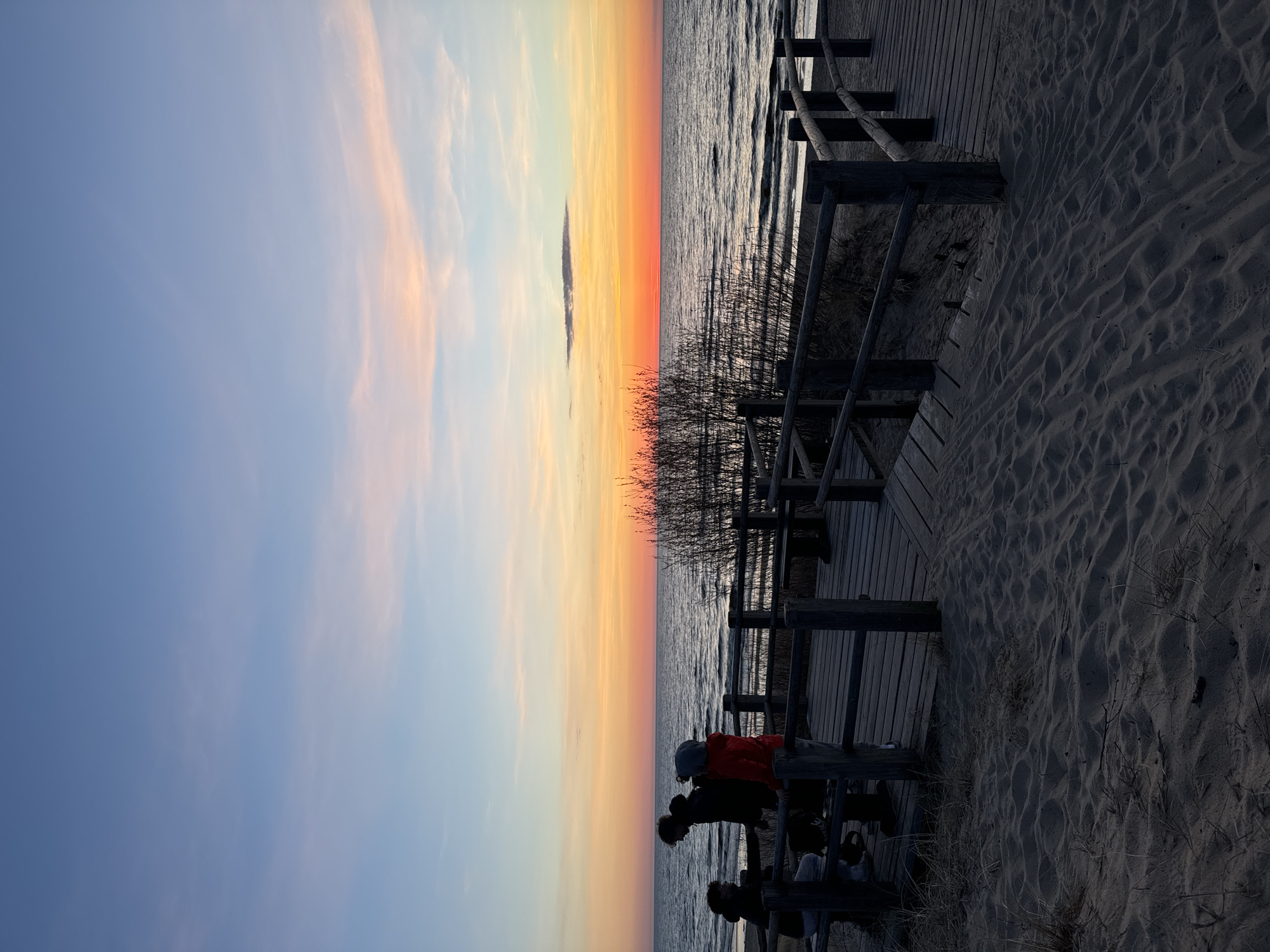 Evening crowd gathers on Riga boardwalk for sunset viewing