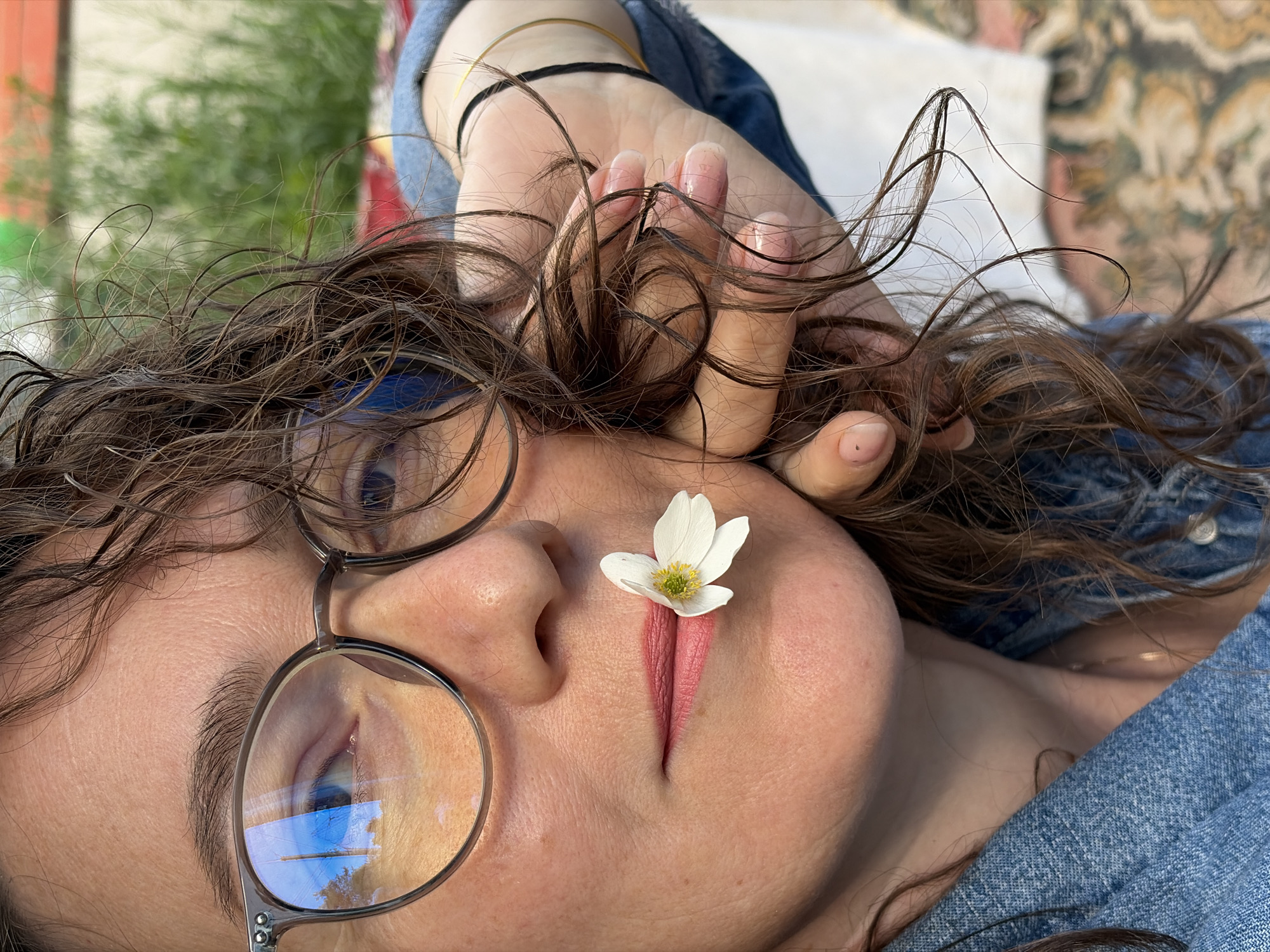 Woman with flowers and pencil photographed in Ol'khovskoye