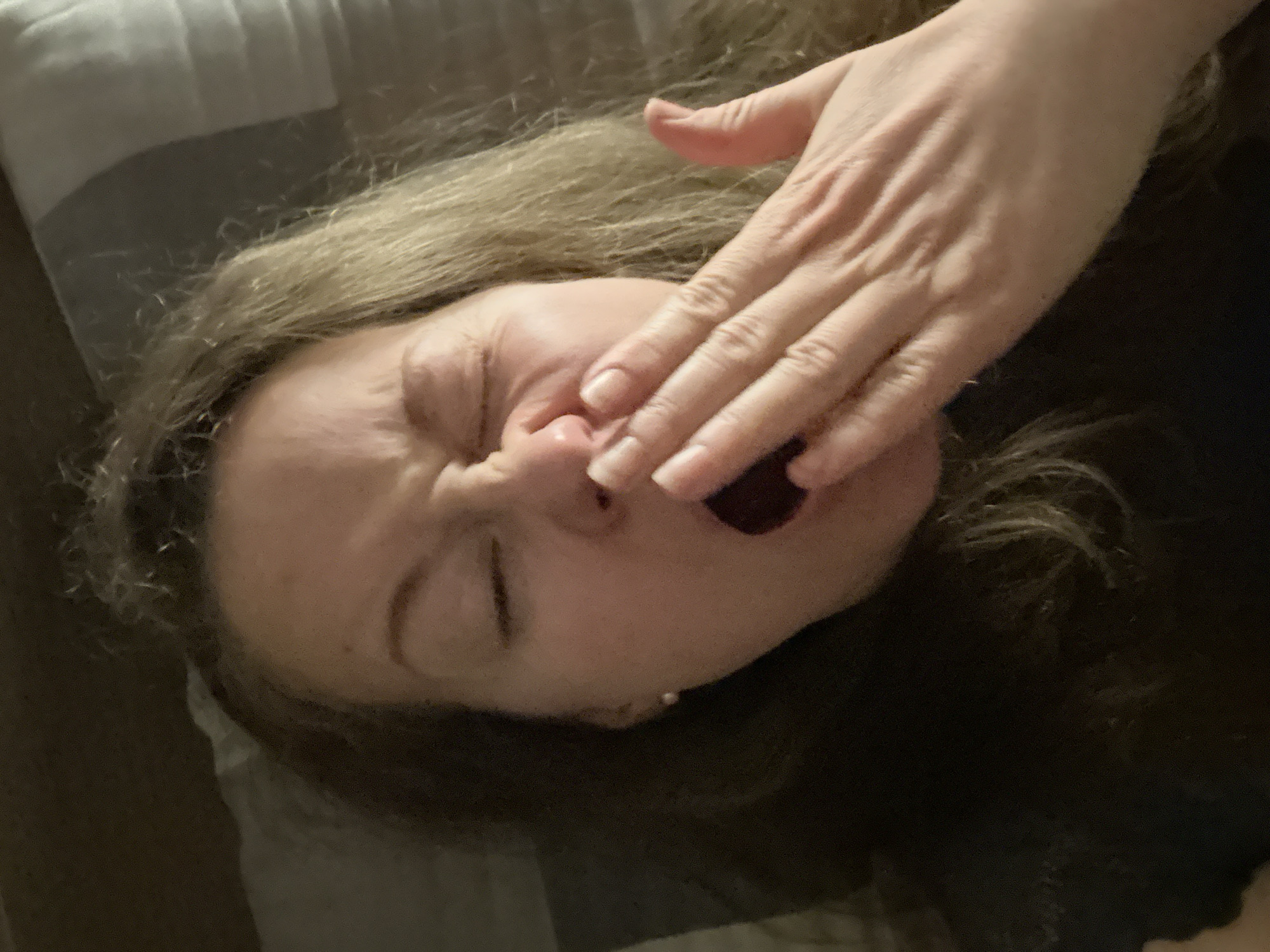 Woman captured yawning in bed during evening hours in Moscow
