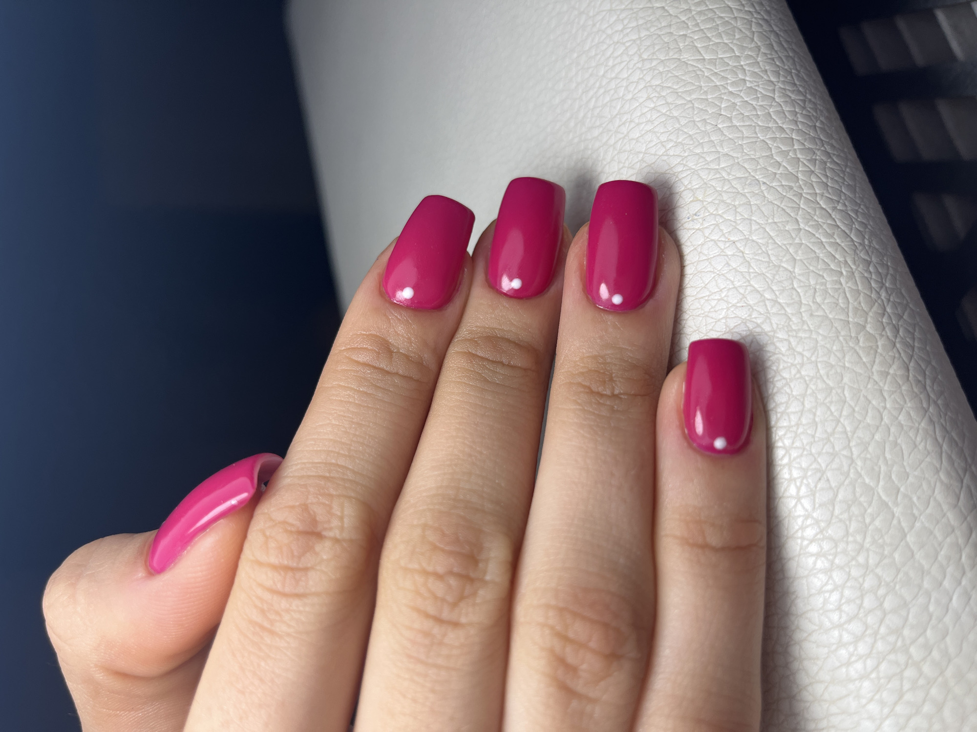 Magenta manicure with white dots photographed in Pernik